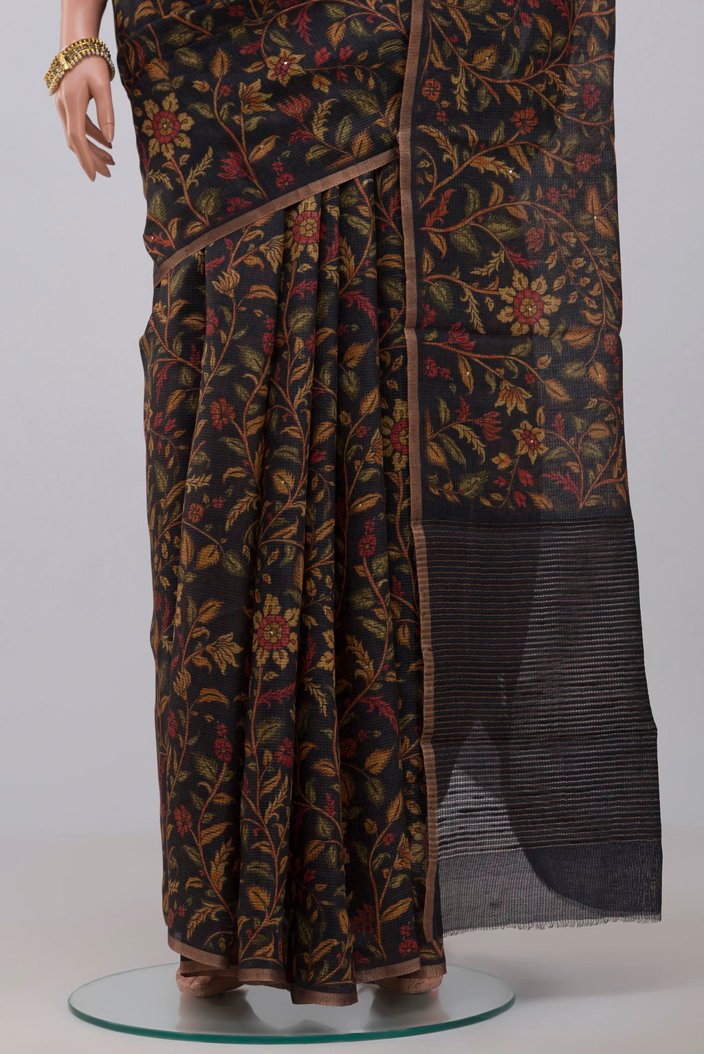 Pleats and pallu of Black Tussar Silk Saree with Printed design on the body and Thin Zari Line. 