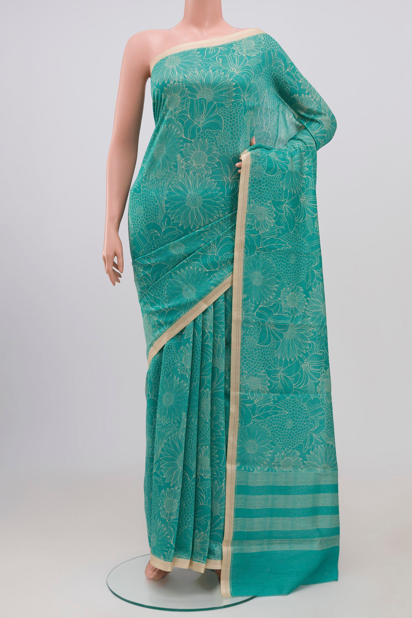 Sky Blue Tussar Silk Saree with Floral Print on the body and Thin Zari Line.  displayed on a mannequin