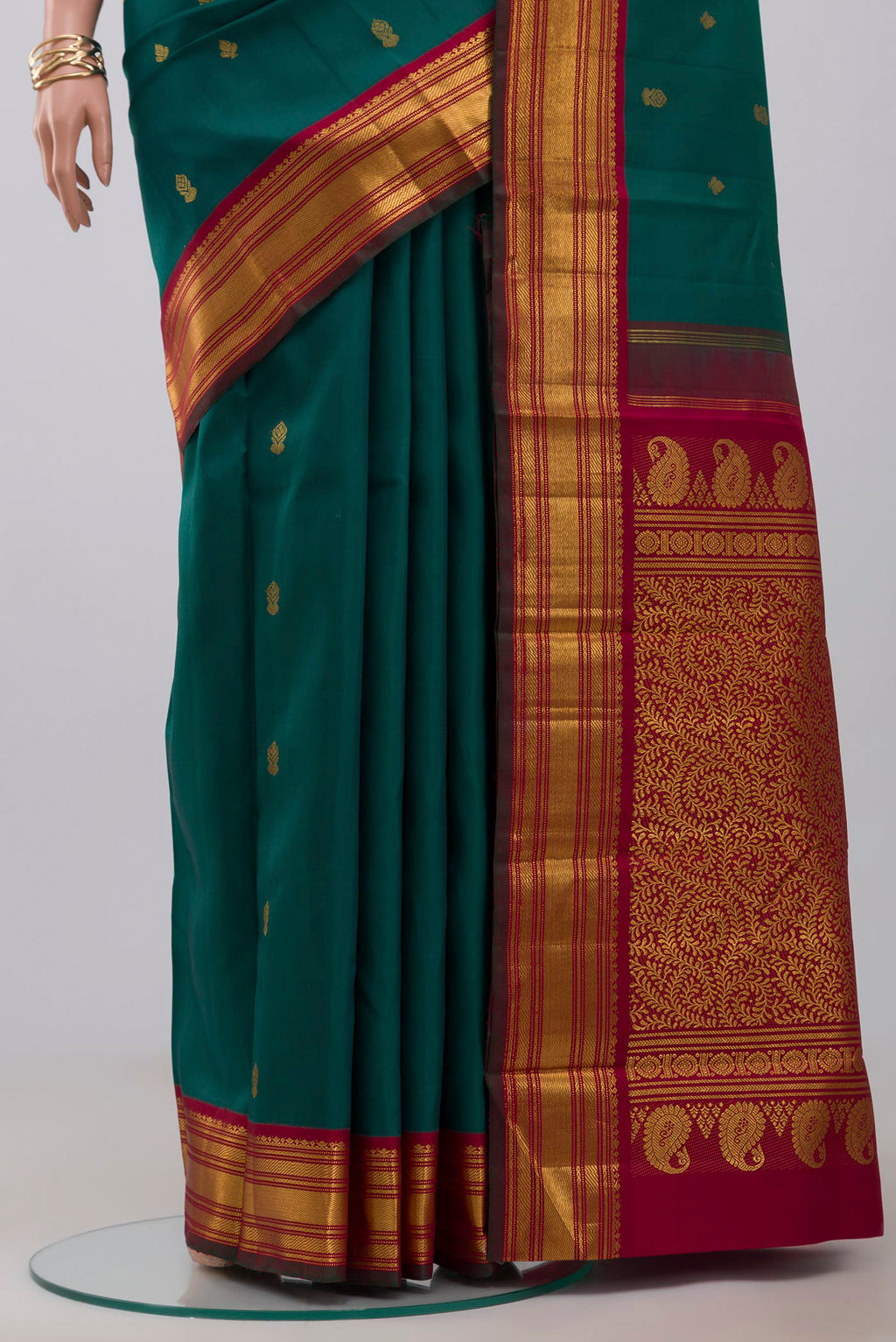 Pleats and pallu of Pure Silk Pure Zari Green Kanchipuram Saree with Zari Butta on the body and Zari Border. 