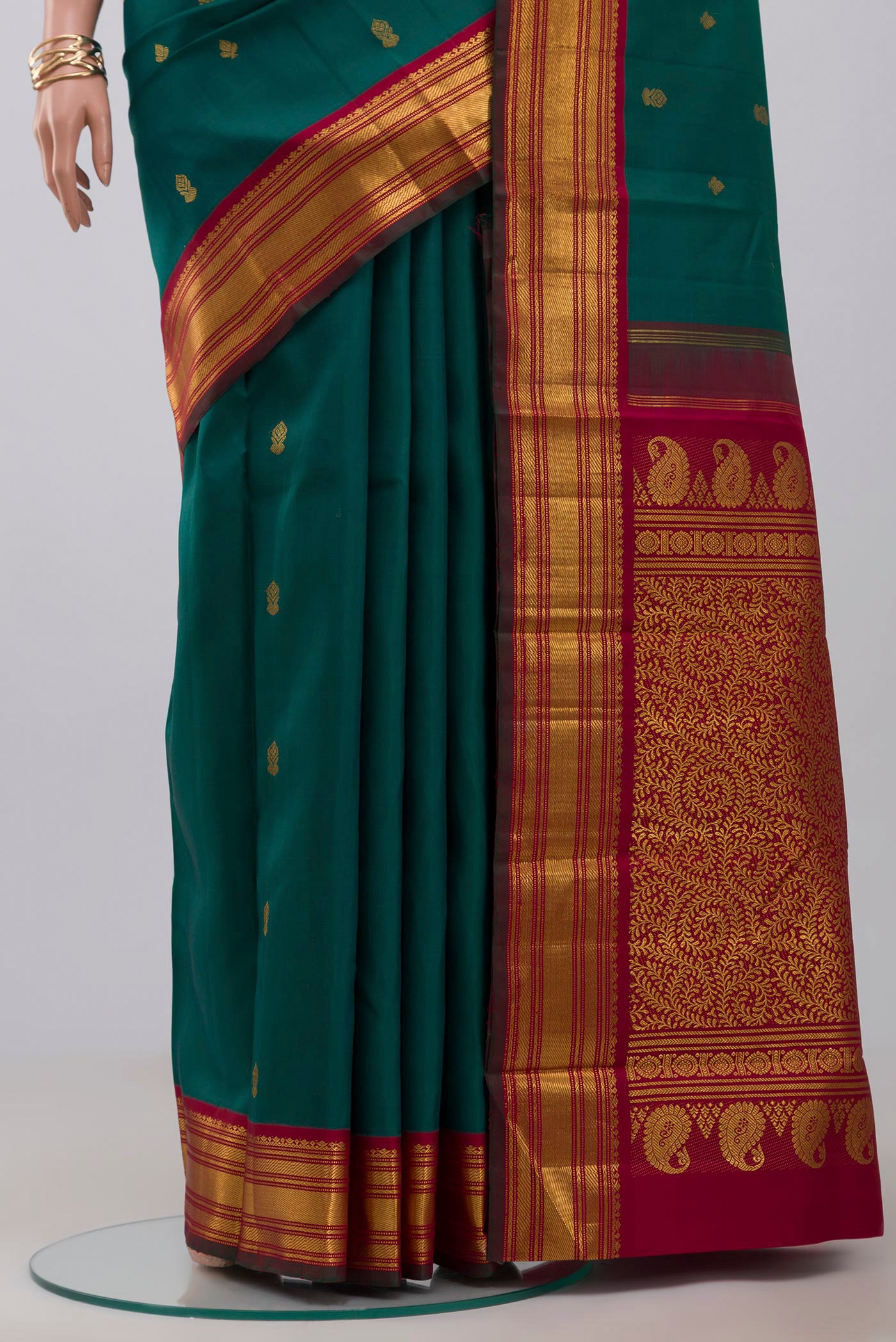 Pleats and pallu of Pure Silk Pure Zari Green Kanchipuram Saree with Zari Butta on the body and Zari Border. 