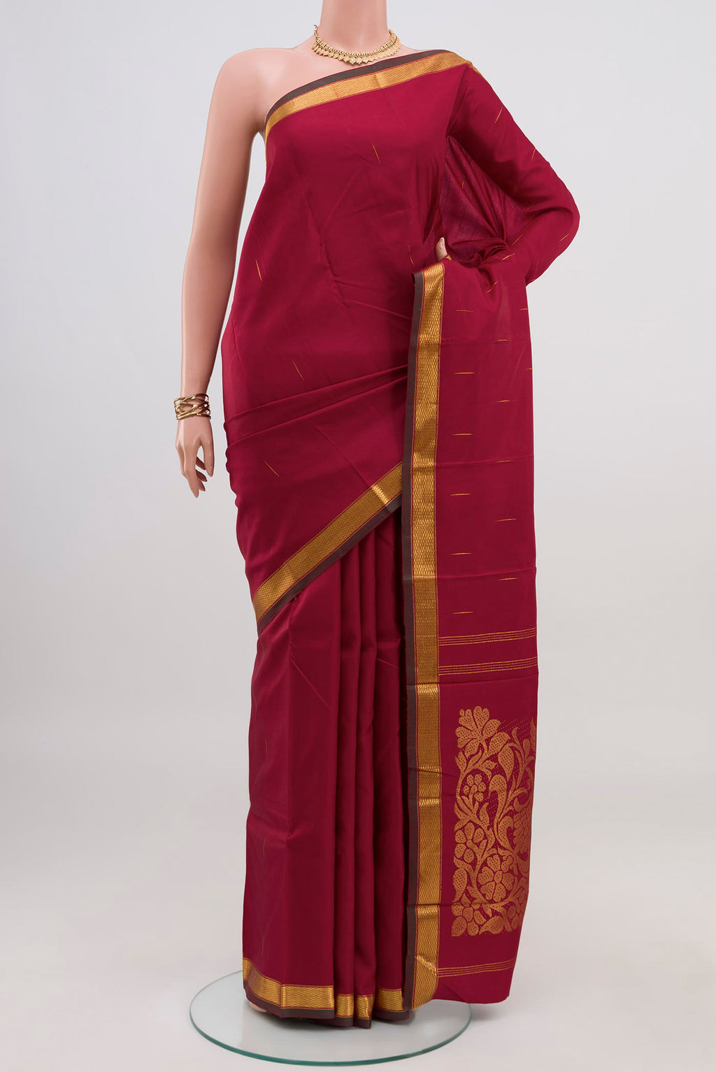 Pure Silk Pure Zari Maroon Kanjivaram Saree with Zari Butta on the body and Zari Border.  displayed on a mannequin