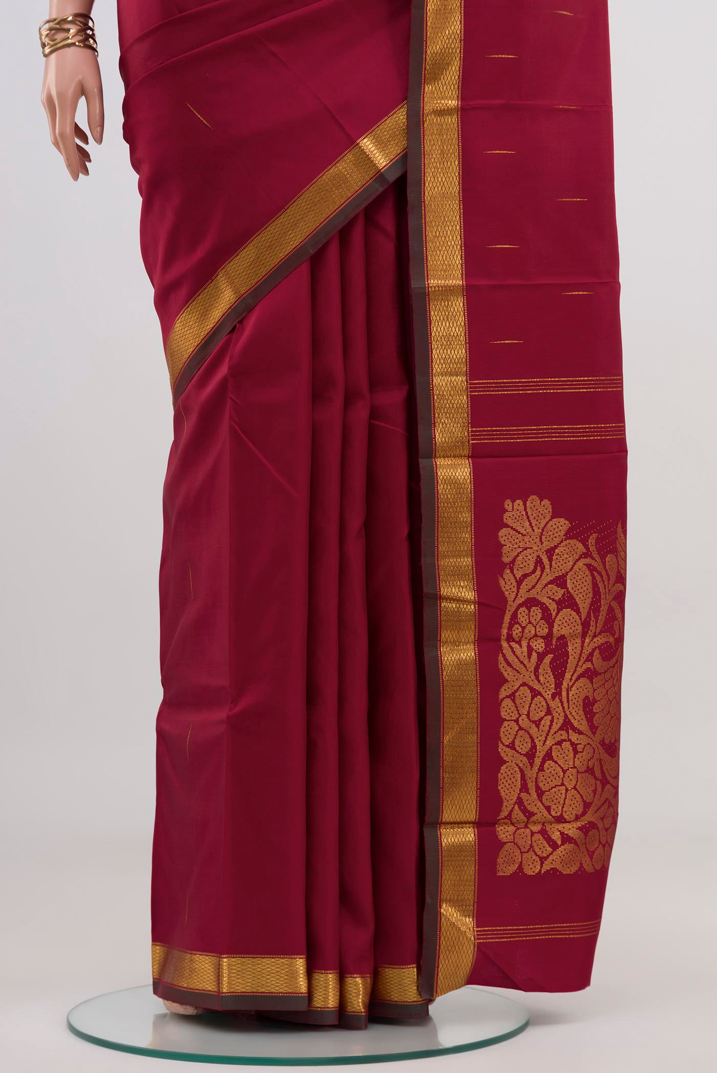 Pleats and pallu of Pure Silk Pure Zari Maroon Kanjivaram Saree with Zari Butta on the body and Zari Border. 