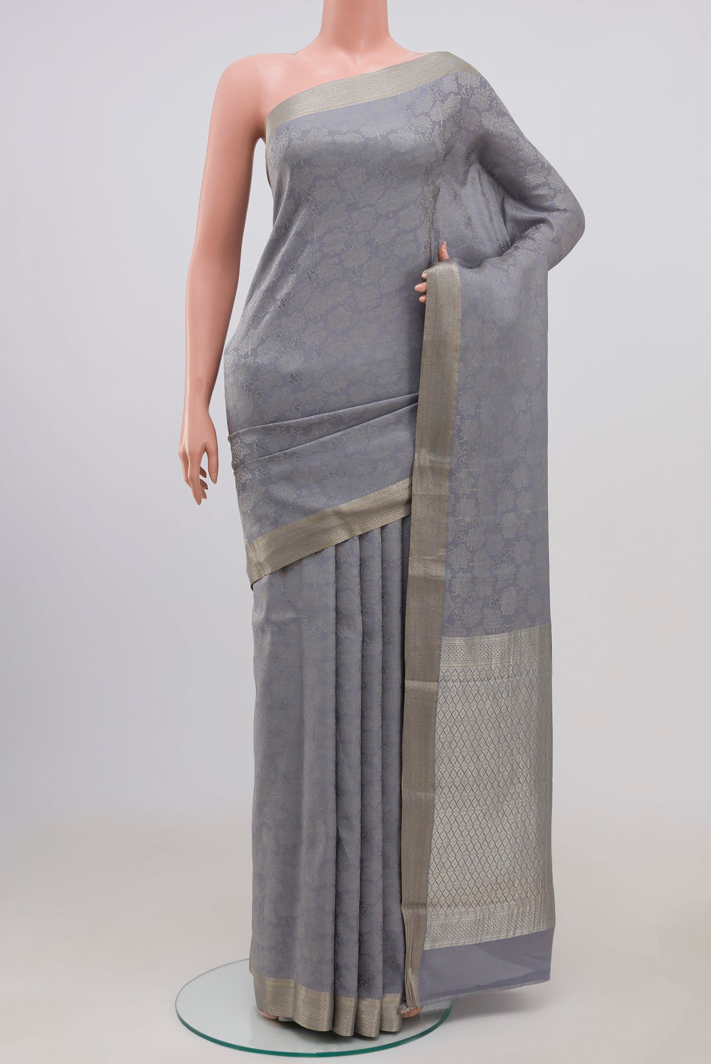 Grey Mysore Crepe Saree with Zari Brocade on the body and Zari Border.  displayed on a mannequin