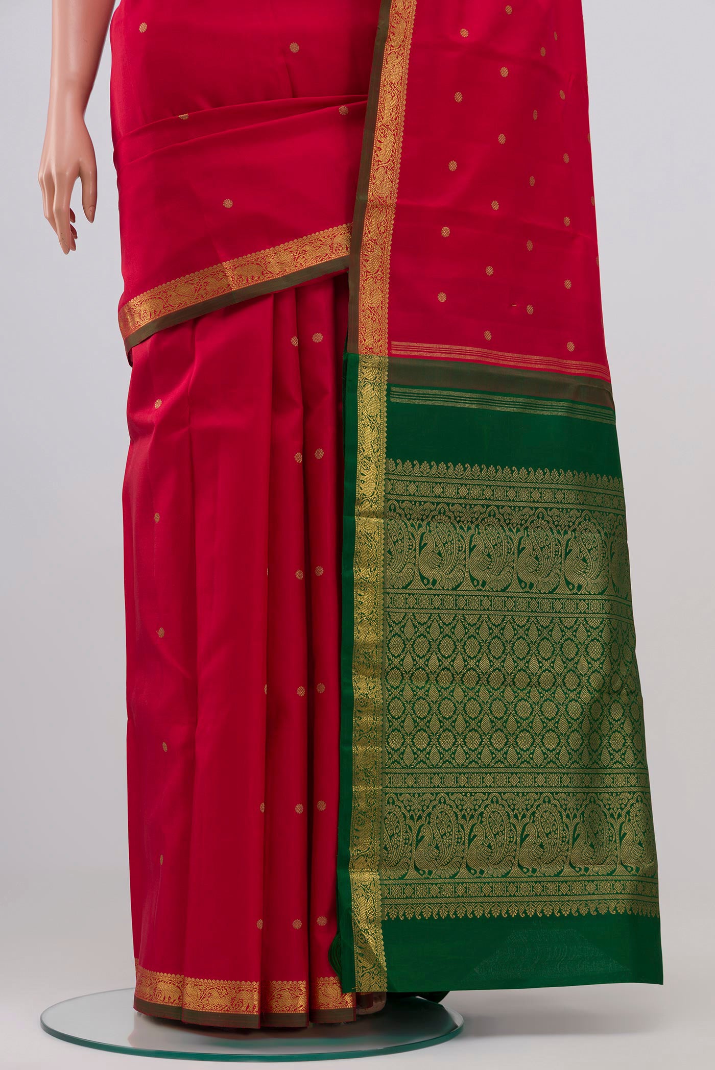 Pleats and pallu of Pure Silk Pure Zari Maroon Kanchipuram Saree with Zari Butta on the body and Zari Border. 