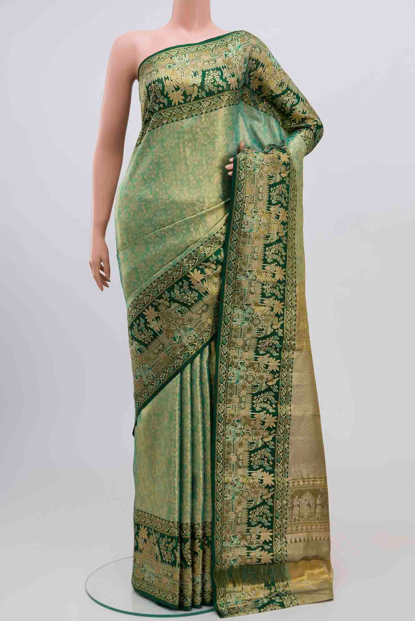 green with gold Color Kanjivaram Tissue Silk Saree with Zari Brocade on the body and Zari Border.  displayed on a mannequin