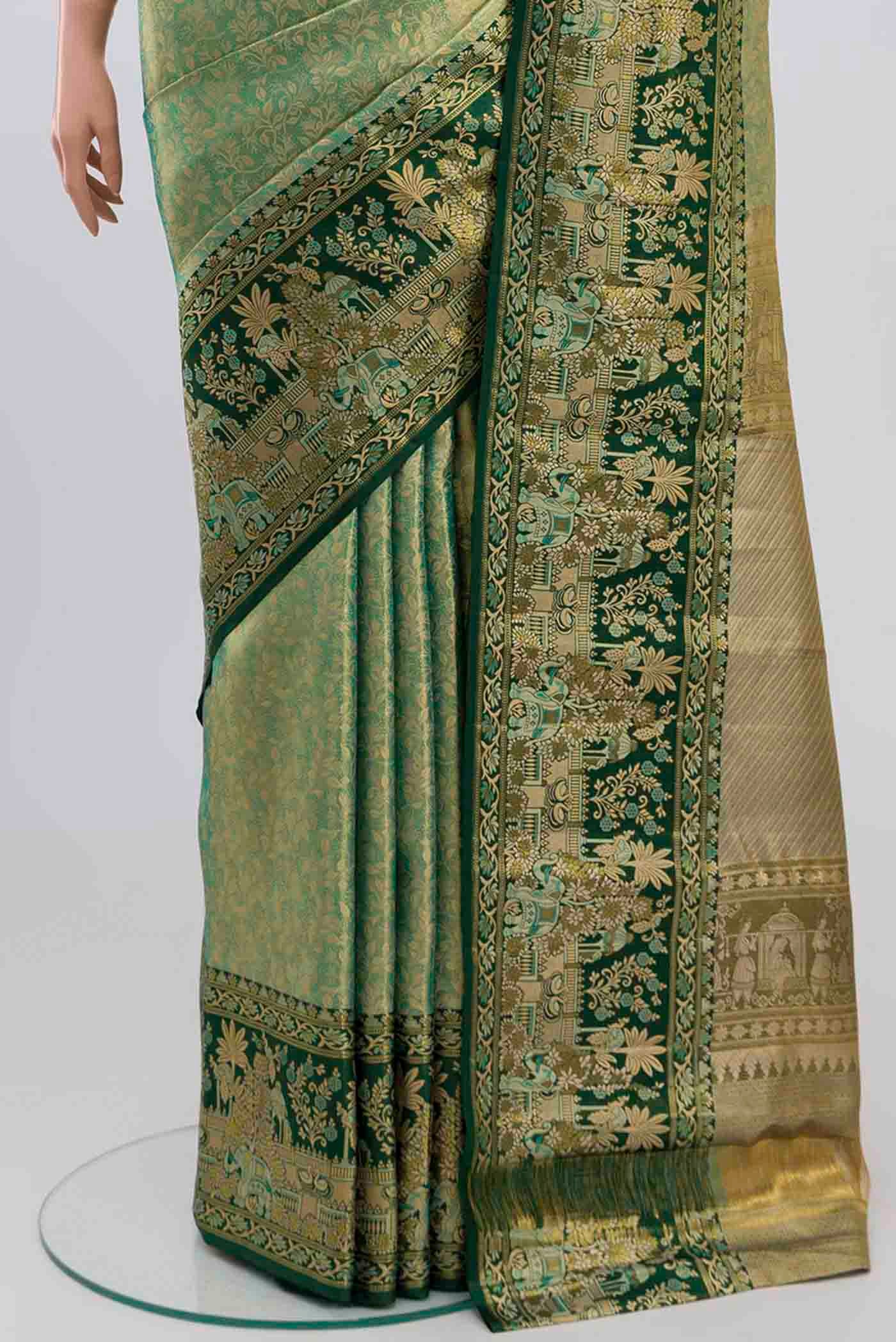 Pleats and pallu of green with gold Color Kanjivaram Tissue Silk Saree with Zari Brocade on the body and Zari Border. 