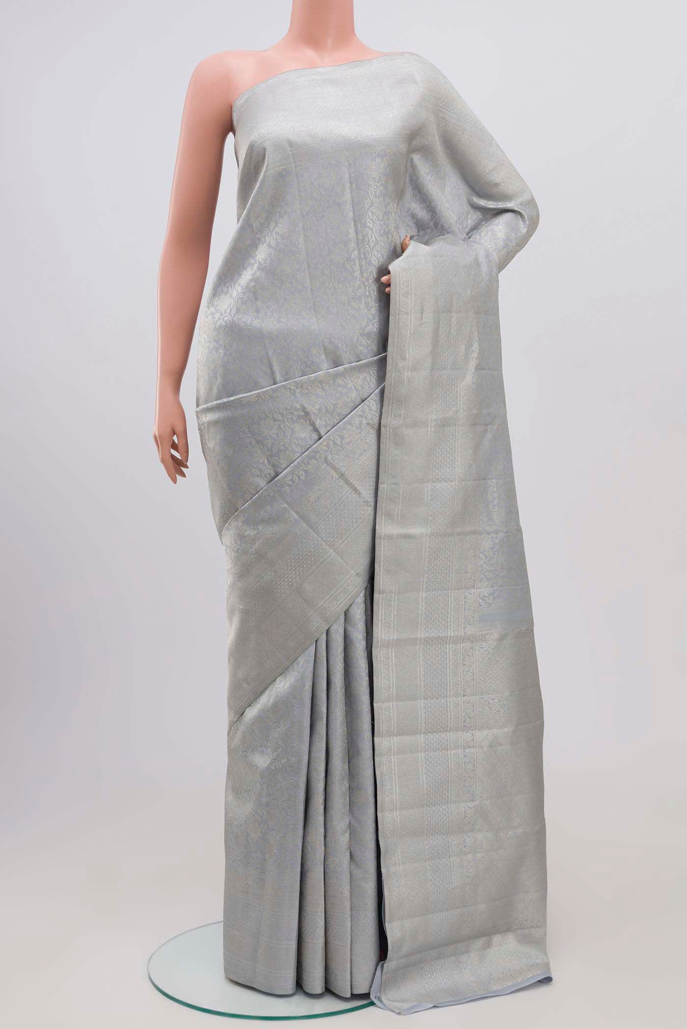 Grey Kanchipuram Silk Saree with Zari Brocade on the body and Zari Border.  displayed on a mannequin