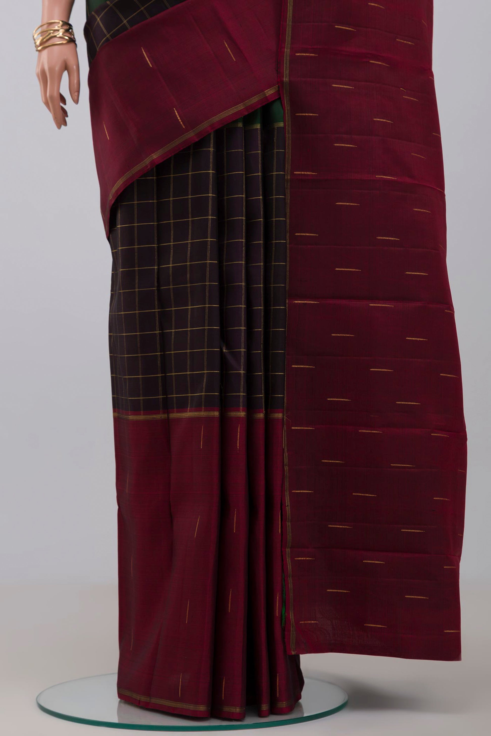 Pleats and pallu of Pure Silk Pure Zari Black Kanchipuram Saree with Checked design on the body and Ganga Jamuna Border. 