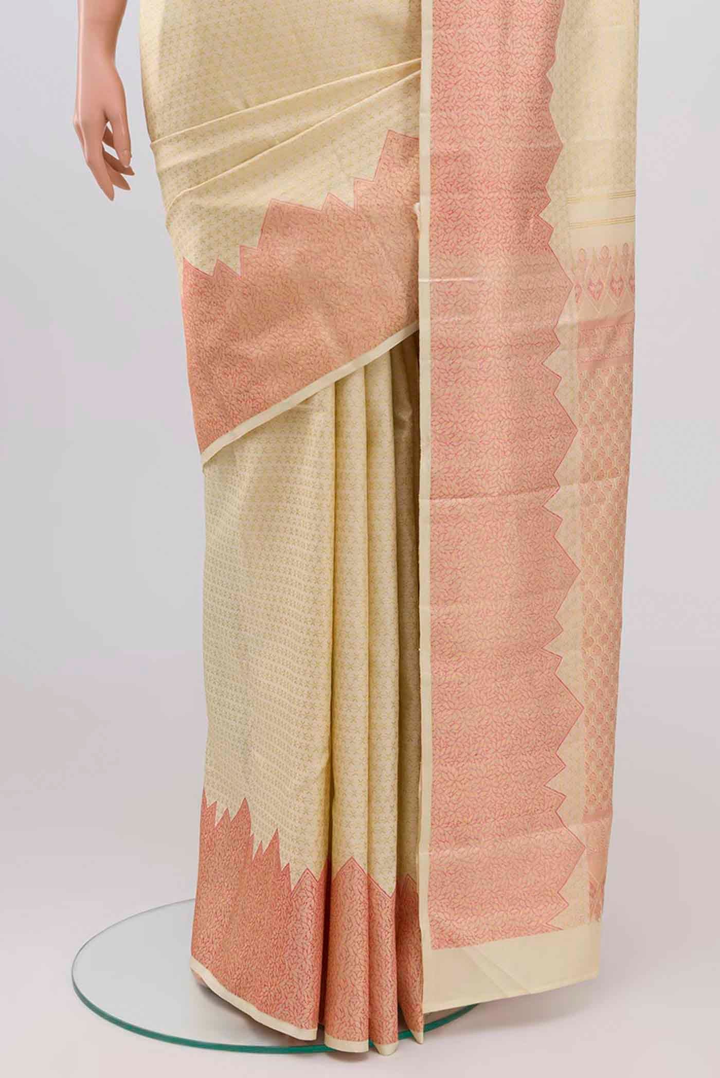 Pleats and pallu of Cream Kanchipuram Silk Saree with Zari Brocade on the body and Temple Border. 