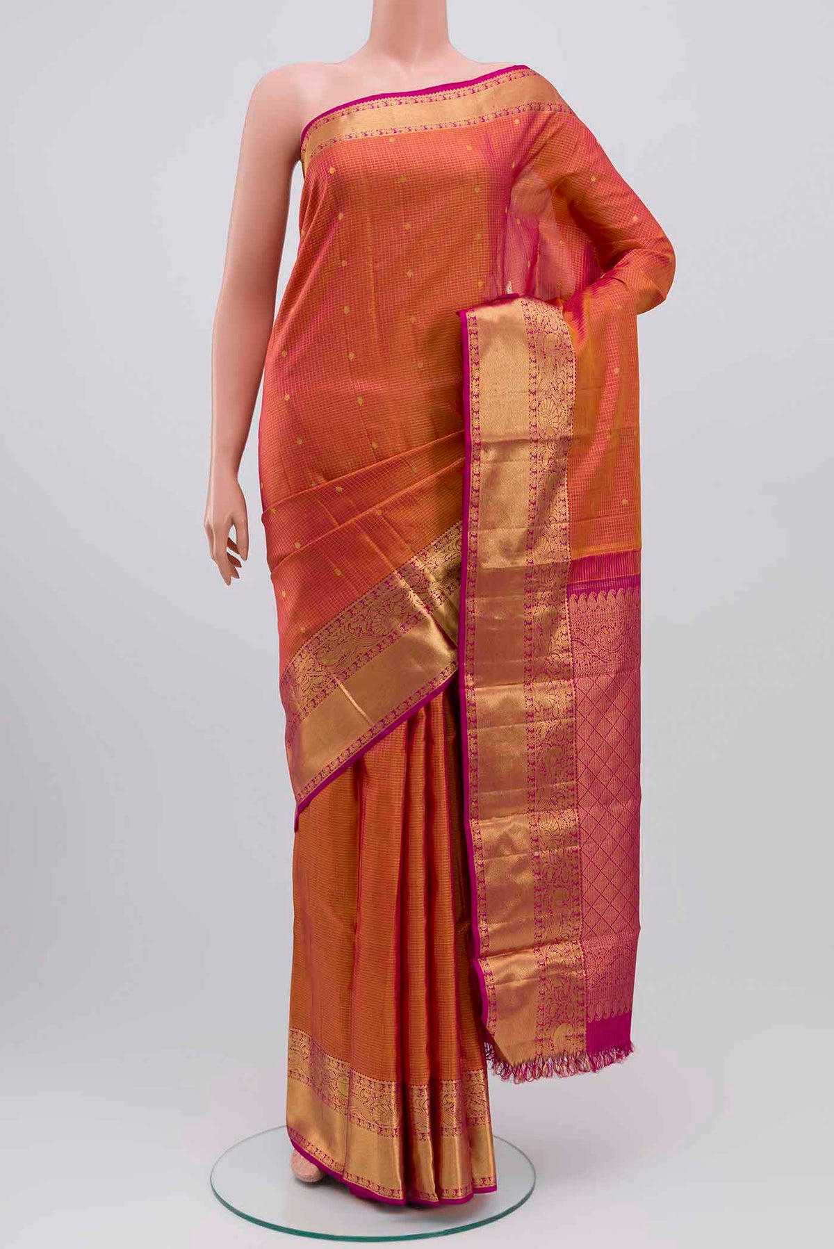 Pink with Mustard Color Kanchipuram Silk Saree with Checked design on the body and Zari Border displayed on a mannequin