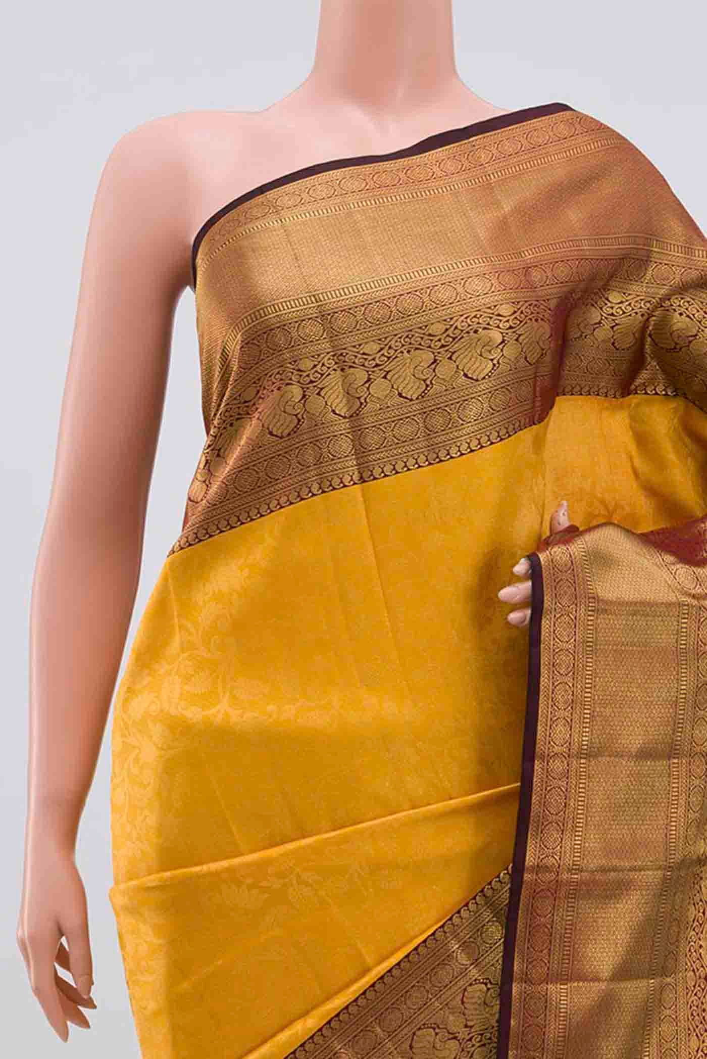Border image of Mustard Kanchipuram Silk Saree with Zari Brocade on the body and Zari Border. 