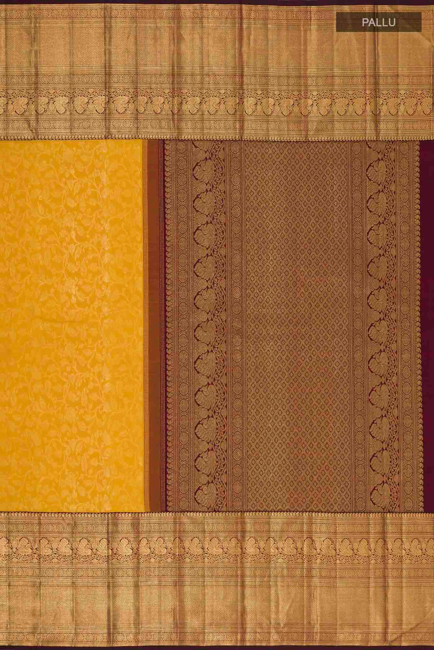 Close up image of the pallu of Mustard Kanchipuram Silk Saree with Zari Brocade on the body and Zari Border. 