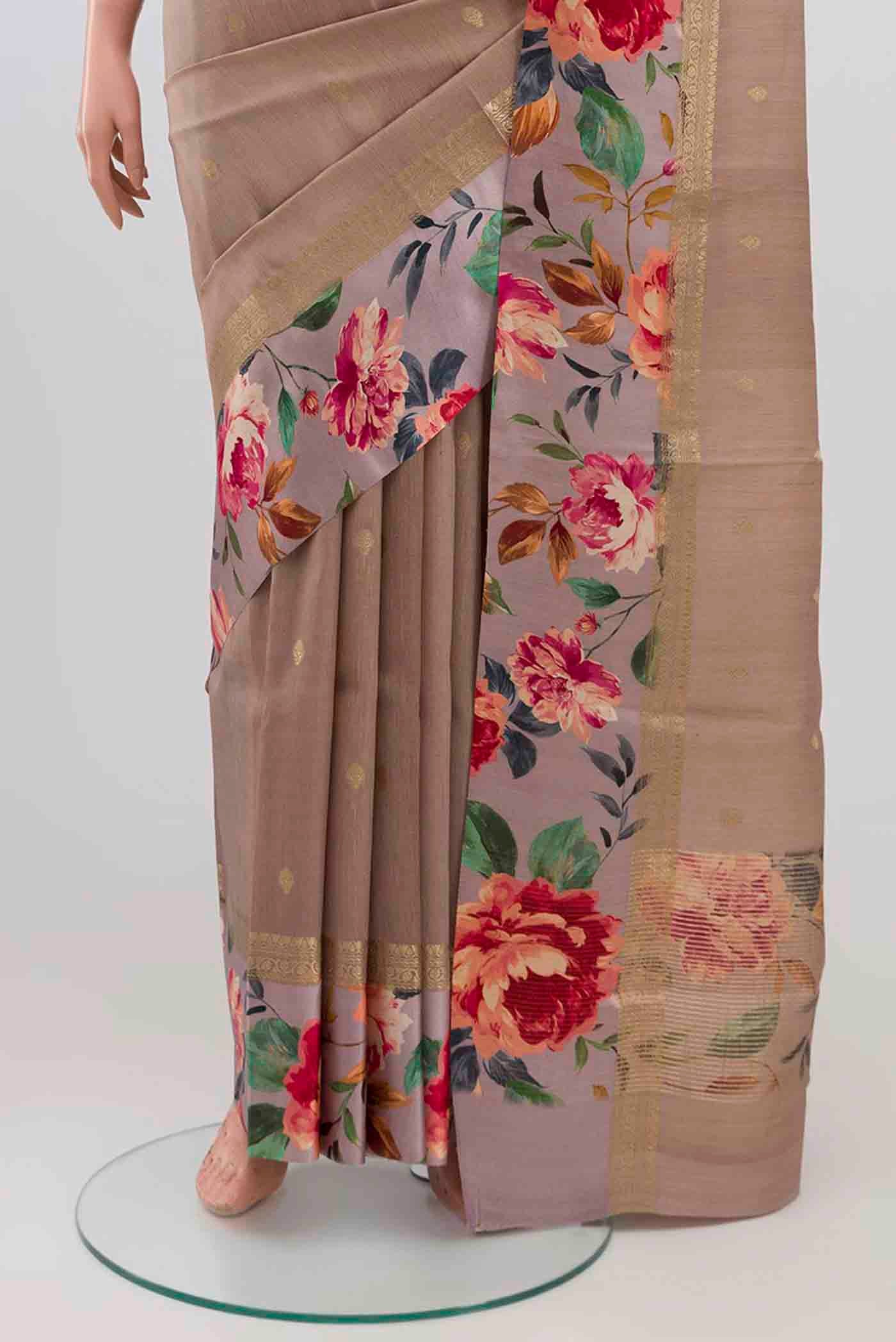 Pleats and pallu of Brown Tussar Silk Saree with Zari Butta on the body and Printed Border. 