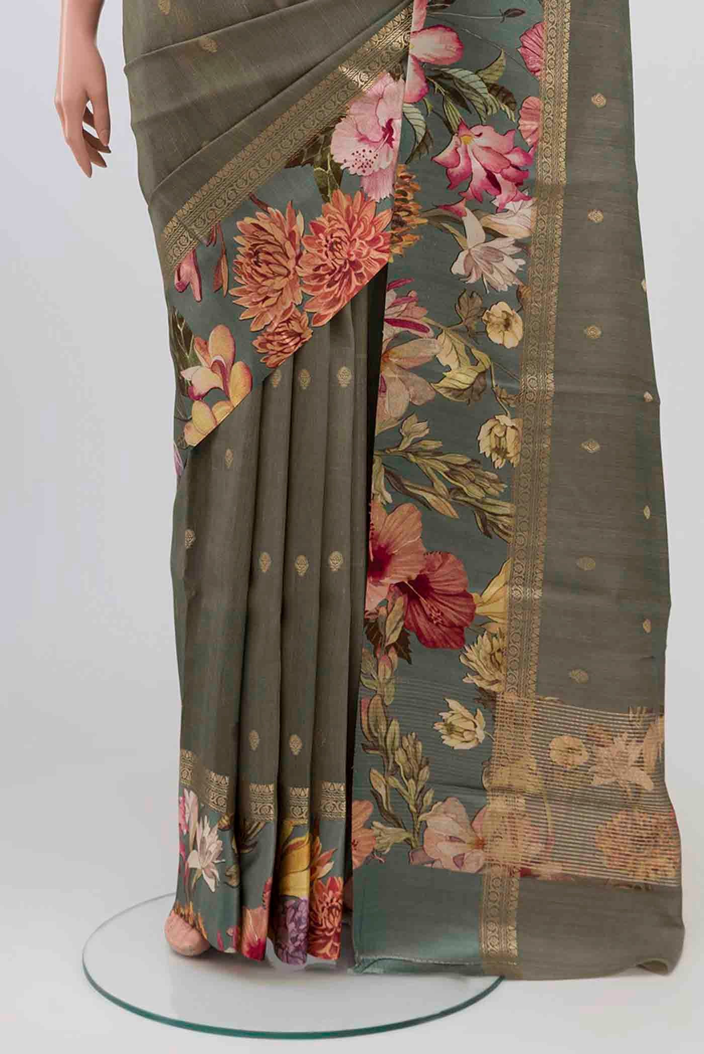 Pleats and pallu of Grey Tussar Silk Saree with Zari Butta on the body and Printed Border. 