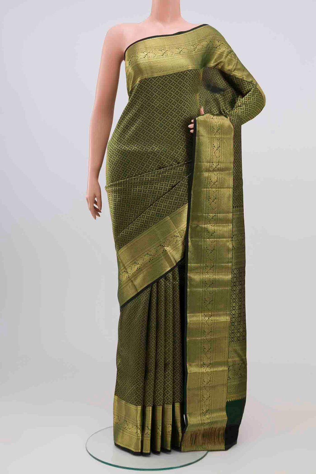 Bottle Green Kanjivaram Silk Saree with Zari Brocade on the body and Zari Border.  displayed on a mannequin