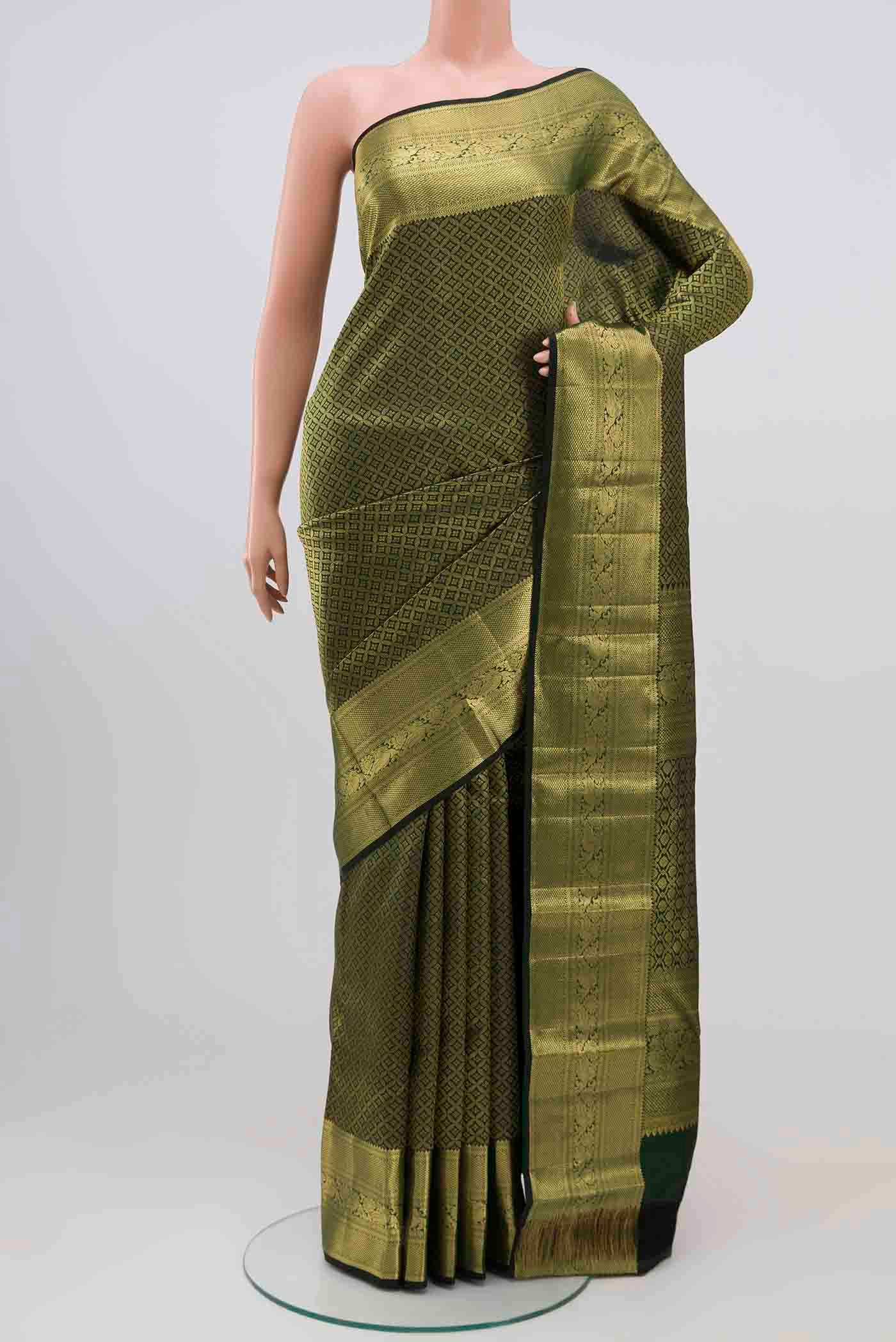 Bottle Green Kanjivaram Silk Saree with Zari Brocade on the body and Zari Border.  displayed on a mannequin