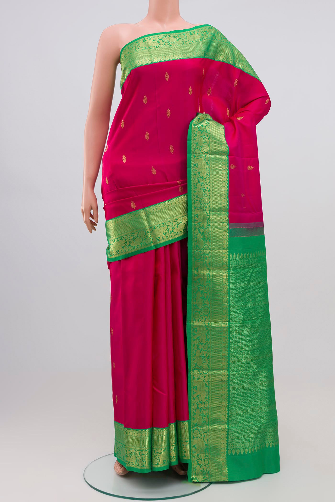 Pink Kanjivaram Silk Saree with Zari Butta on the body and Zari Border.  displayed on a mannequin