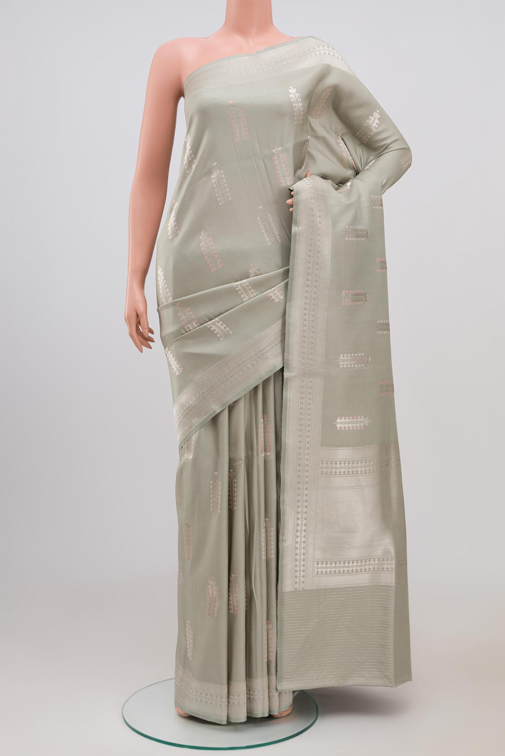 Grey Banarasi Silk Saree with Zari Butta on the body and Zari Border.  displayed on a mannequin