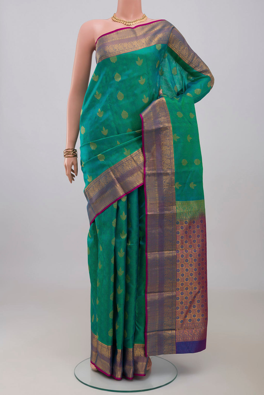 Turquoise Kanchipuram Silk Saree with Jacquard With Zari Butta on the body and Zari Border.  displayed on a mannequin