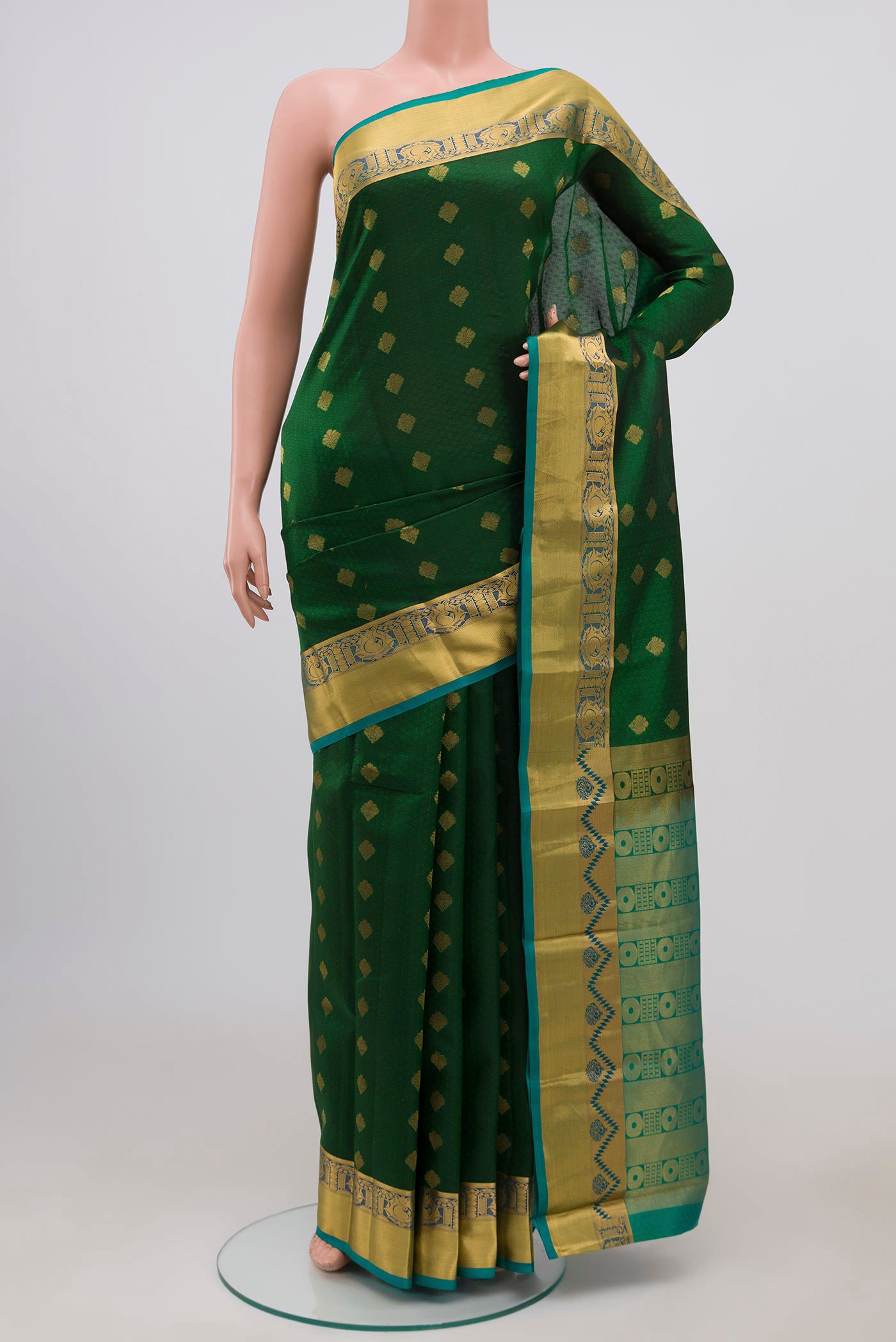 Bottle Green Kanchipuram Silk Saree with Jacquard design on the body and Zari Border.  displayed on a mannequin