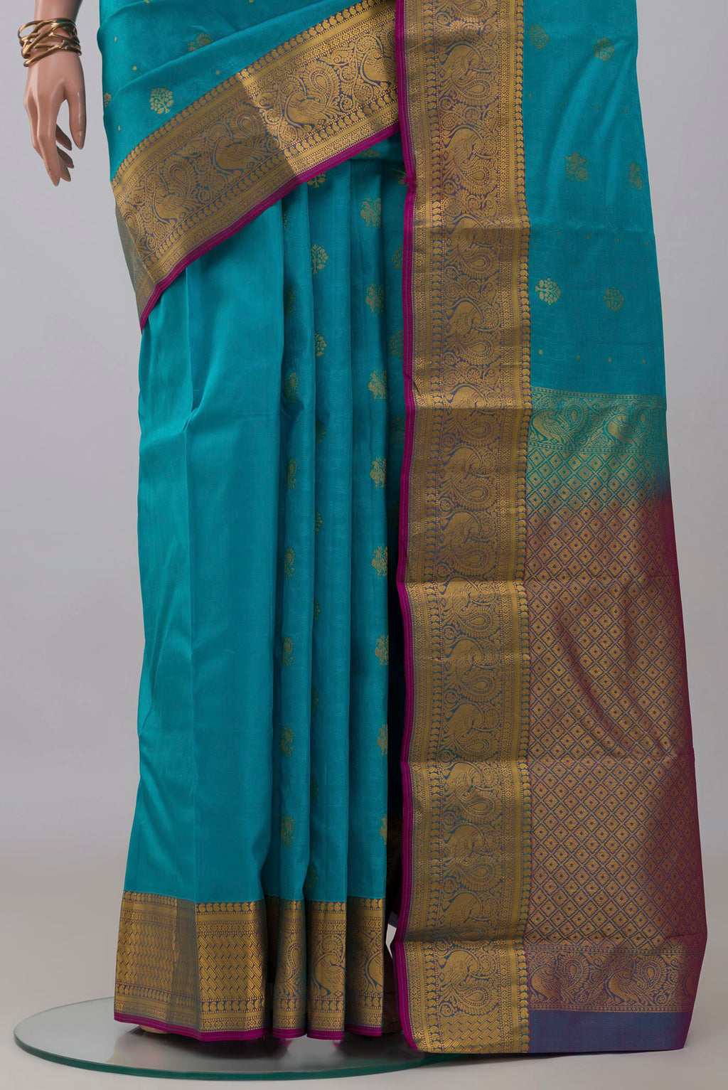 Pleats and pallu of Blue Kanchipuram Silk Saree with Jacquard With Zari Butta on the body and Zari Border. 