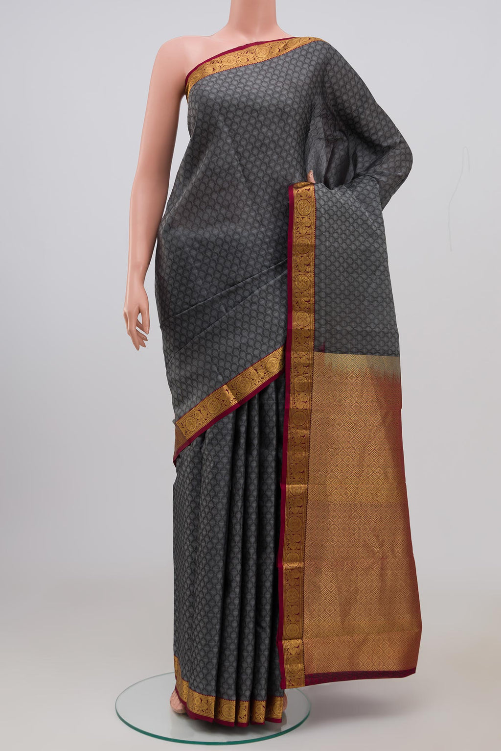 Grey Kanjivaram Saree with Jacquard design on the body and Zari Border.  displayed on a mannequin