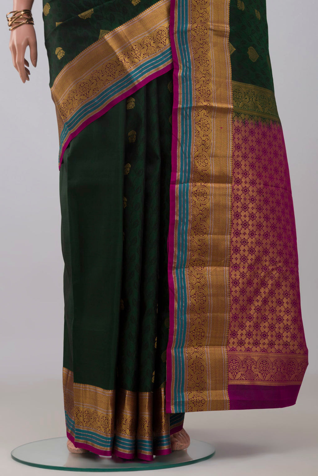 Pleats and pallu of Bottle Green Kanchipuram Silk Saree with Jacquard With Zari Butta on the body and Zari Border. 