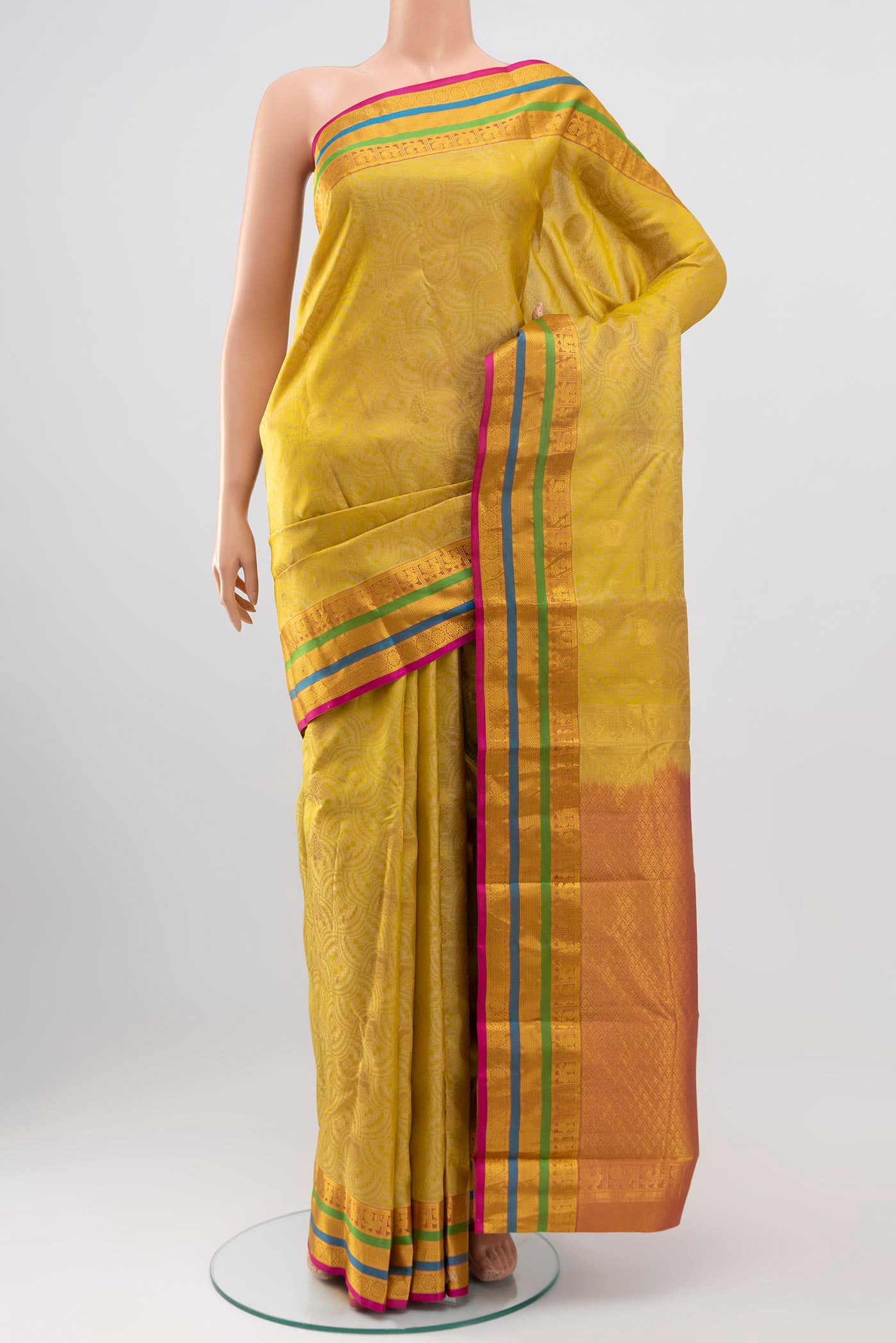 Cream Kanchipuram Silk Saree with Jacquard design on the body and Zari Border.  displayed on a mannequin