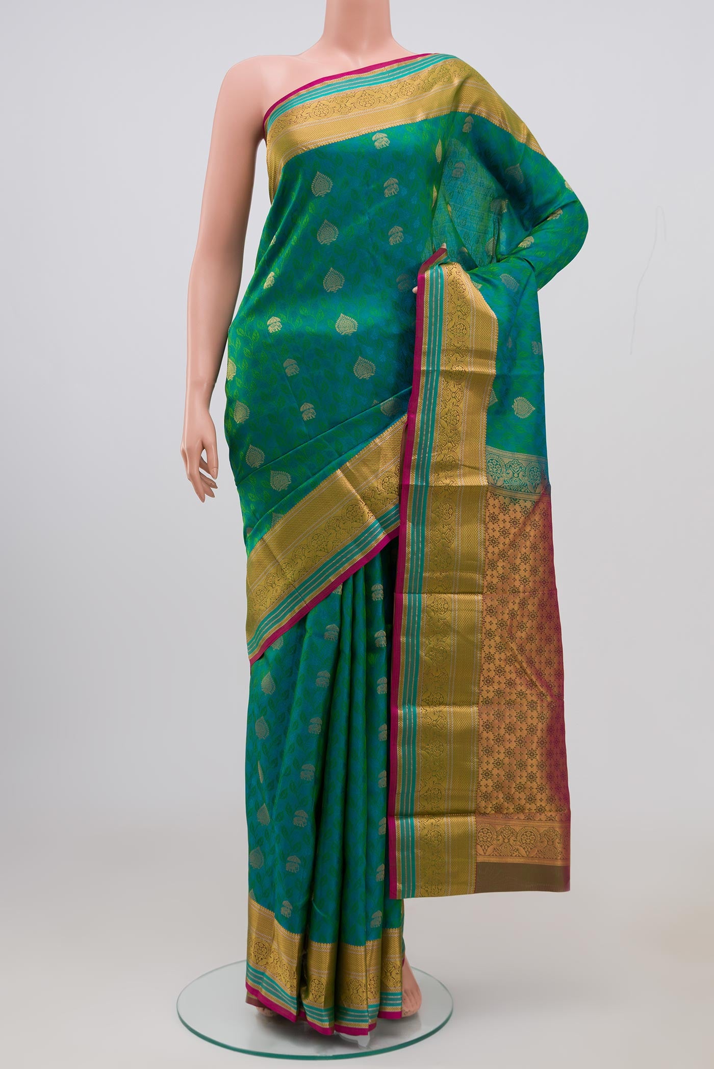 Green Kanchipuram Saree with Jacquard With Zari Butta on the body and Zari Border.  displayed on a mannequin