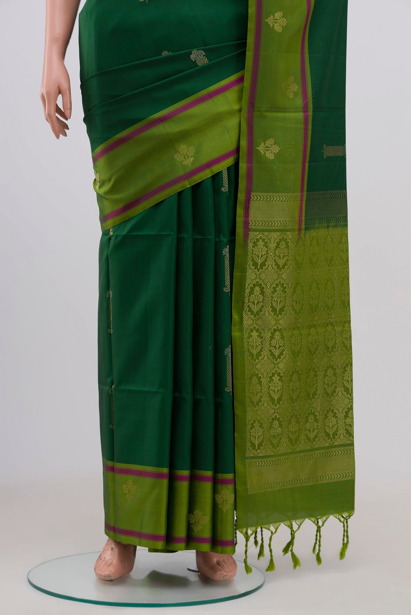 Pleats and pallu of Green Soft Silk Saree with Zari Butta on the body and Fancy Border. 