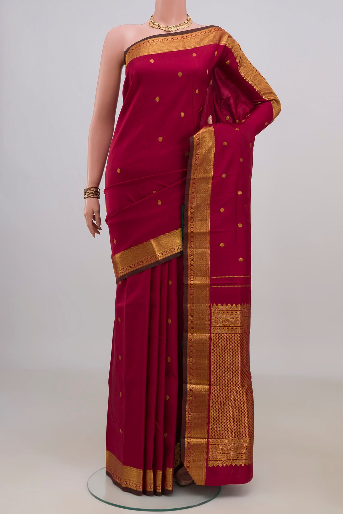 Pure Silk Pure Zari Maroon Kanchipuram Saree with Zari Butta on the body and Zari Border.  displayed on a mannequin