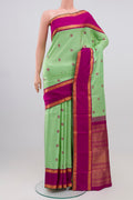 Pure Silk Pure Zari Pista Green Kanchipuram Saree with Zari Butta on the body and Zari Border.  displayed on a mannequin