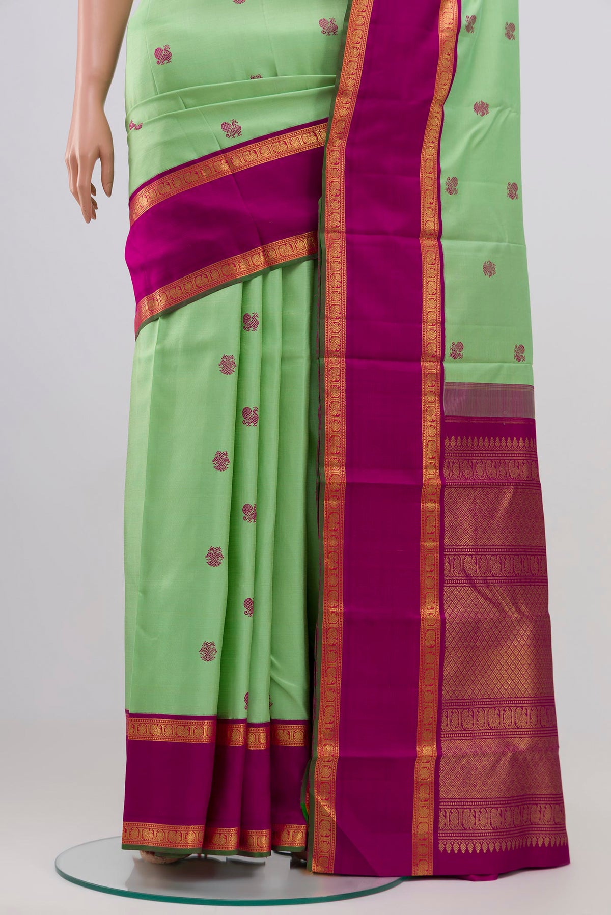 Pleats and pallu of Pure Silk Pure Zari Pista Green Kanchipuram Saree with Zari Butta on the body and Zari Border. 
