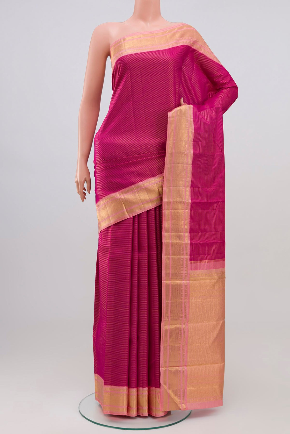 Pure Silk Pure Zari Magenta Kanchipuram Saree with Stripes on the body and Zari Border.  displayed on a mannequin