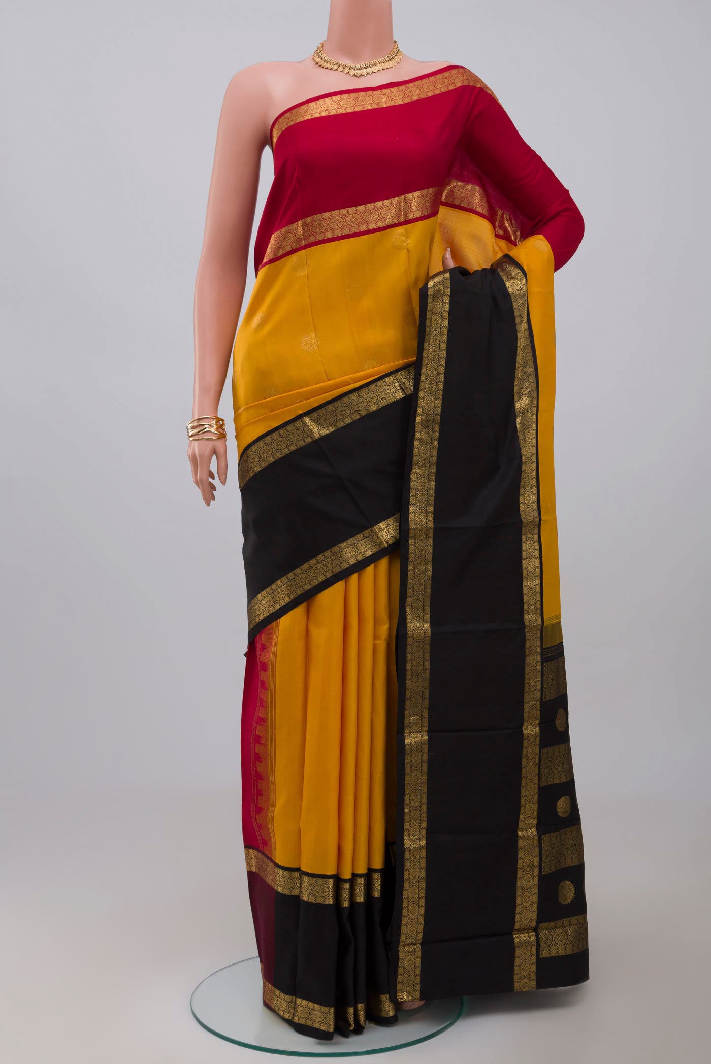 Pure Silk Pure Zari Yellow Kanjivaram Saree with Zari Butta on the body and Ganga Jamuna Border.  displayed on a mannequin