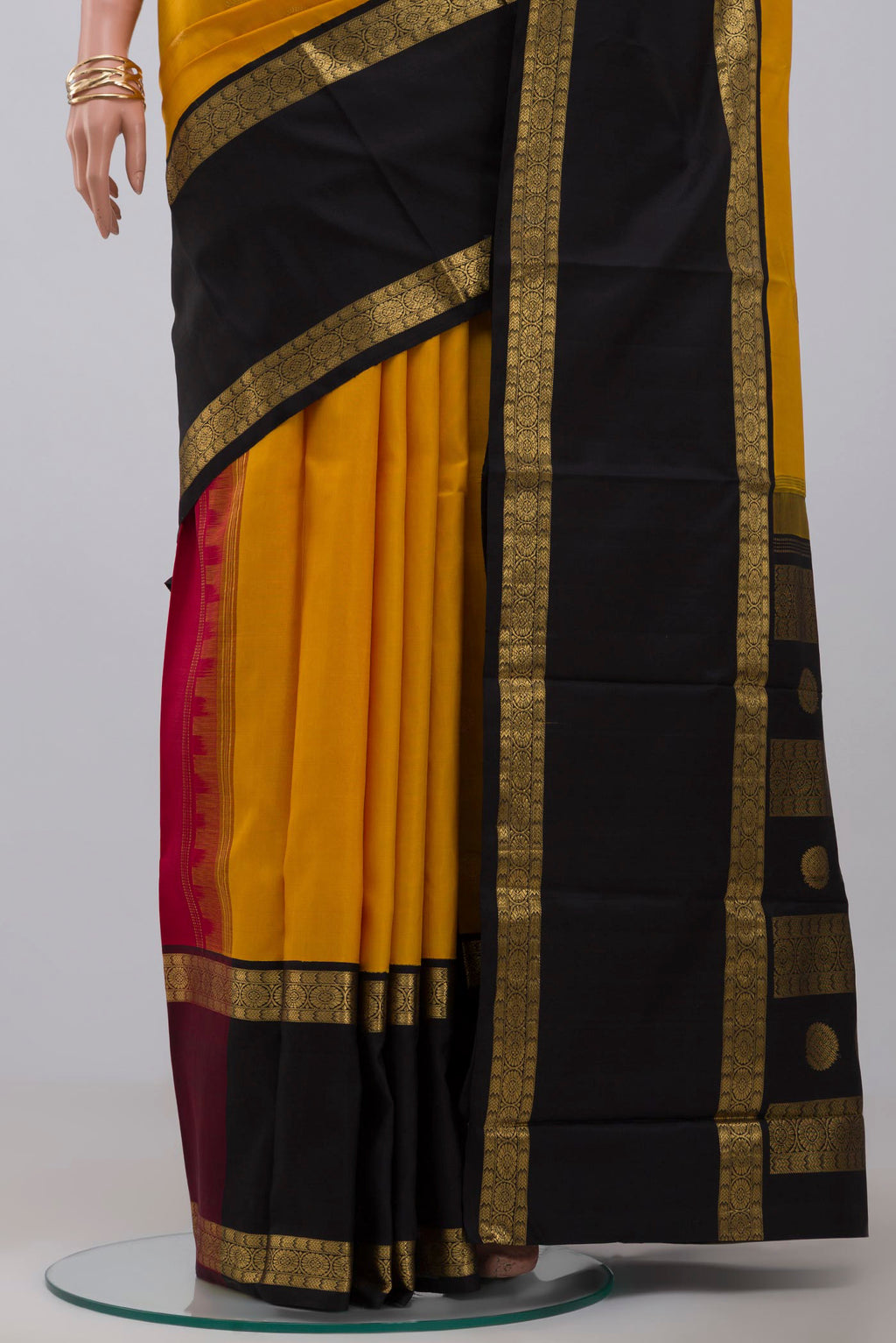 Pleats and pallu of Pure Silk Pure Zari Yellow Kanjivaram Saree with Zari Butta on the body and Ganga Jamuna Border. 