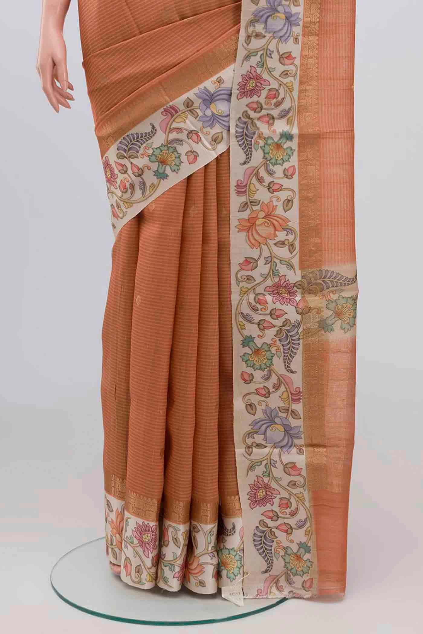 Pleats and pallu of Peach Tussar Silk Saree with Zari Butta on the body and Printed Border. 