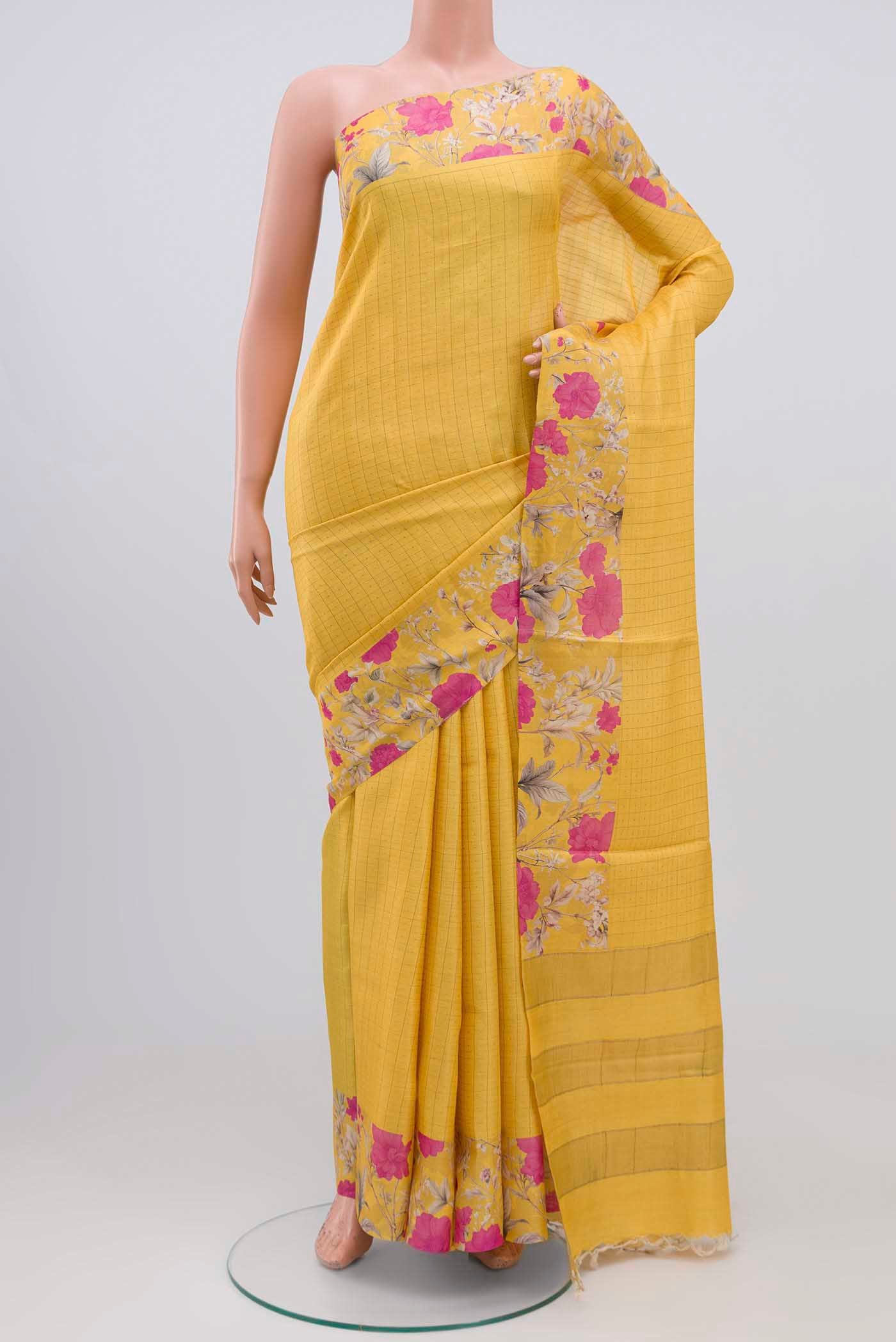 Yellow Tussar Silk Saree with Checked design on the body and Printed Border.  displayed on a mannequin