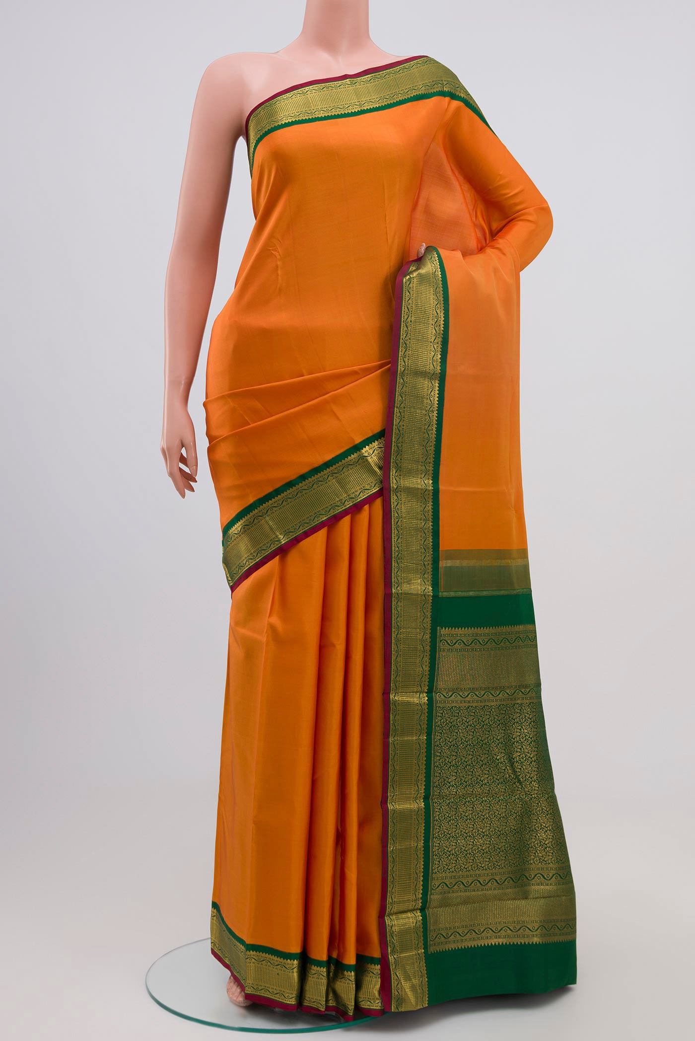 Pure Silk Pure Zari Orange Kanchipuram Saree with Plain Body and Zari Border.  displayed on a mannequin