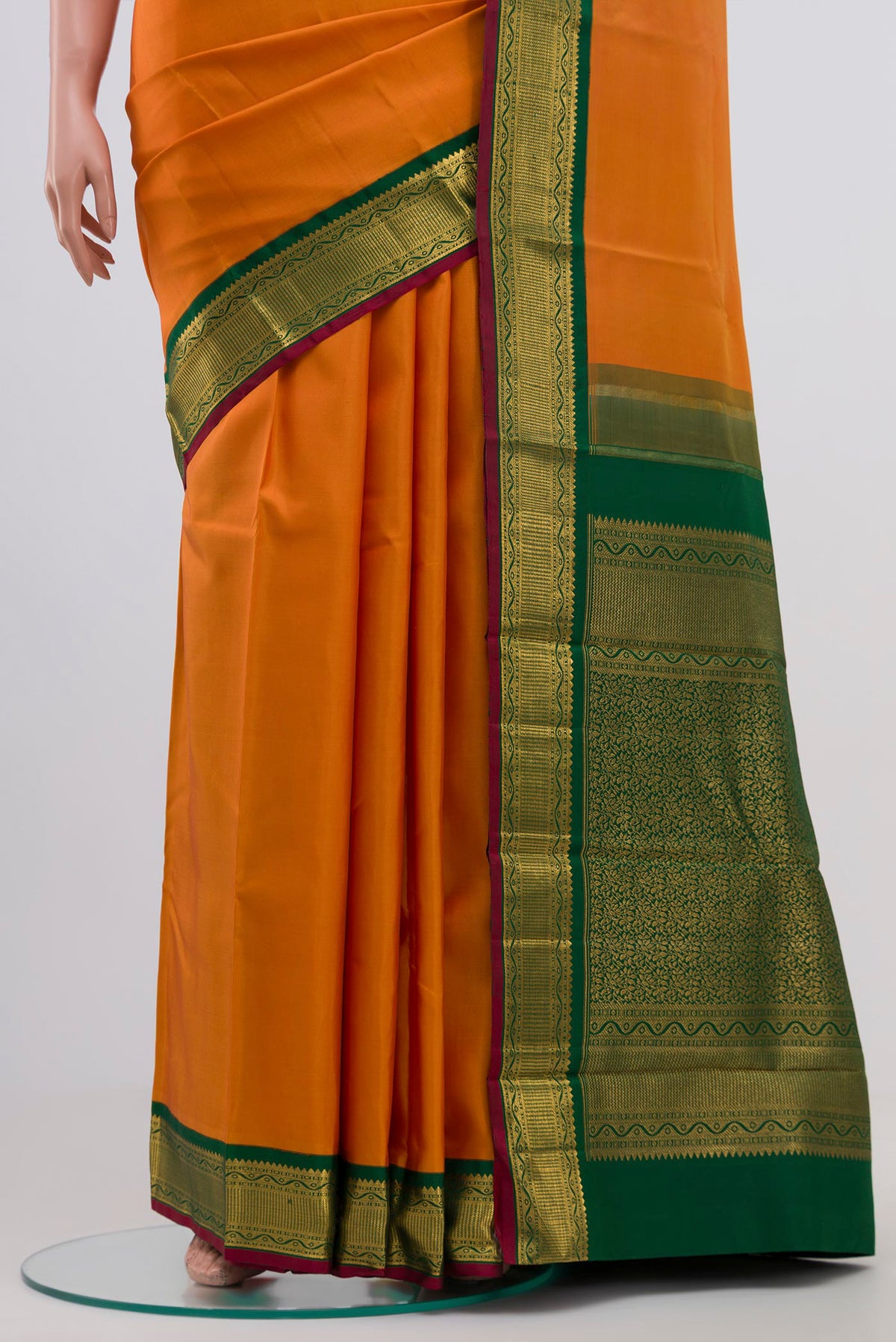 Pleats and pallu of Pure Silk Pure Zari Orange Kanchipuram Saree with Plain Body and Zari Border. 