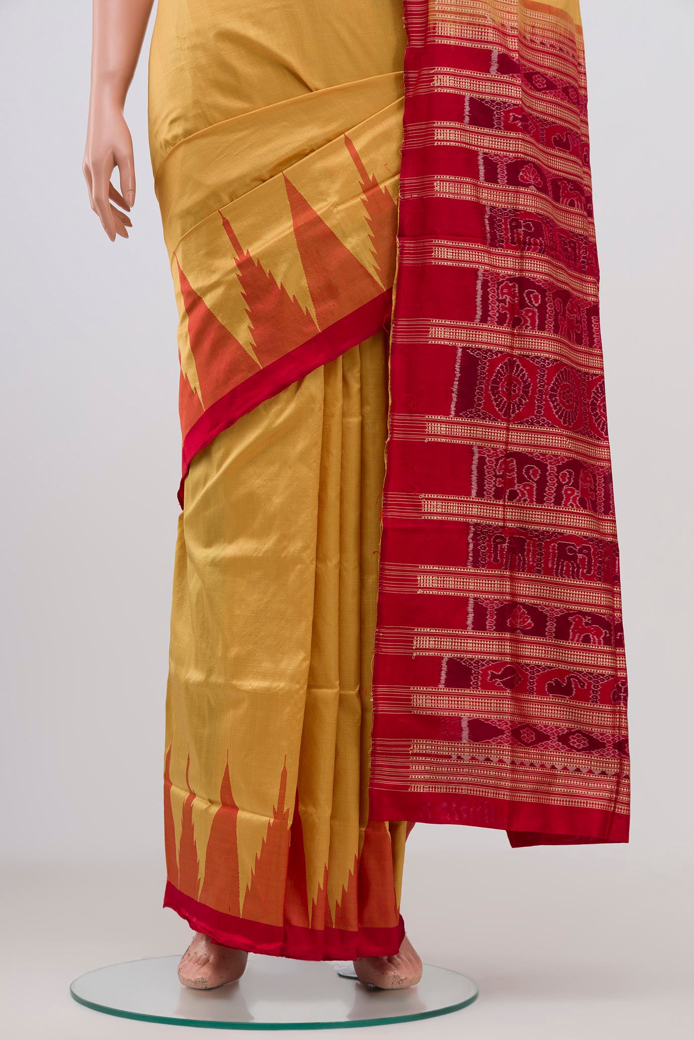 Pleats and pallu of Mustard Orissa Silk Saree with Plain Body and Temple Border. 