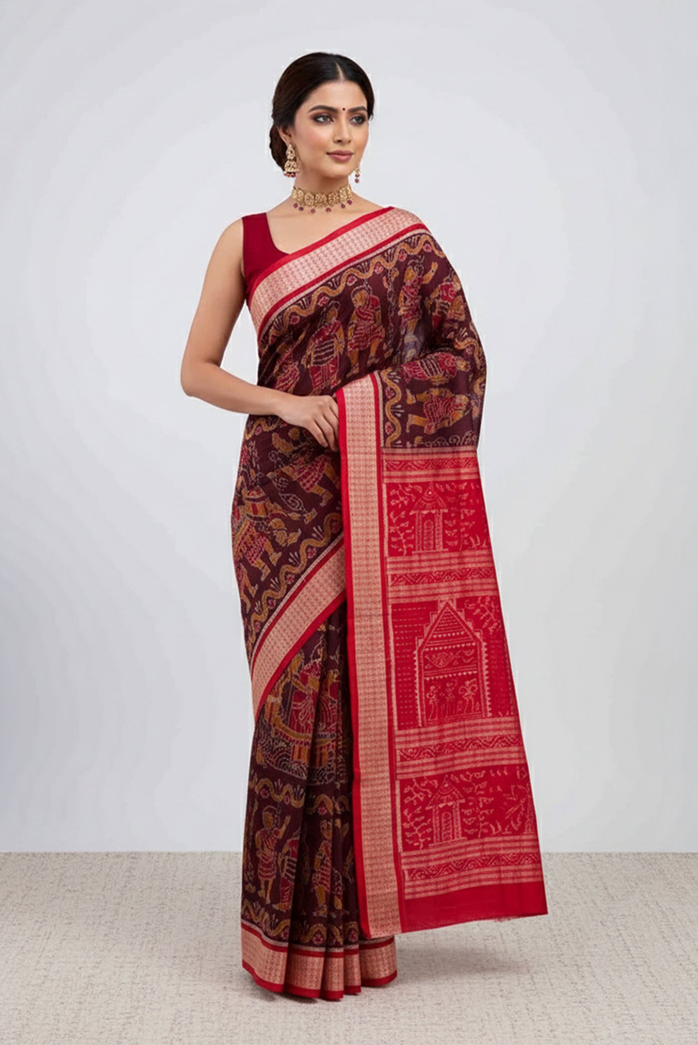 Model wearing a Coffee Brown Orissa Silk Saree with Pure Ikat on the body and Thread Border