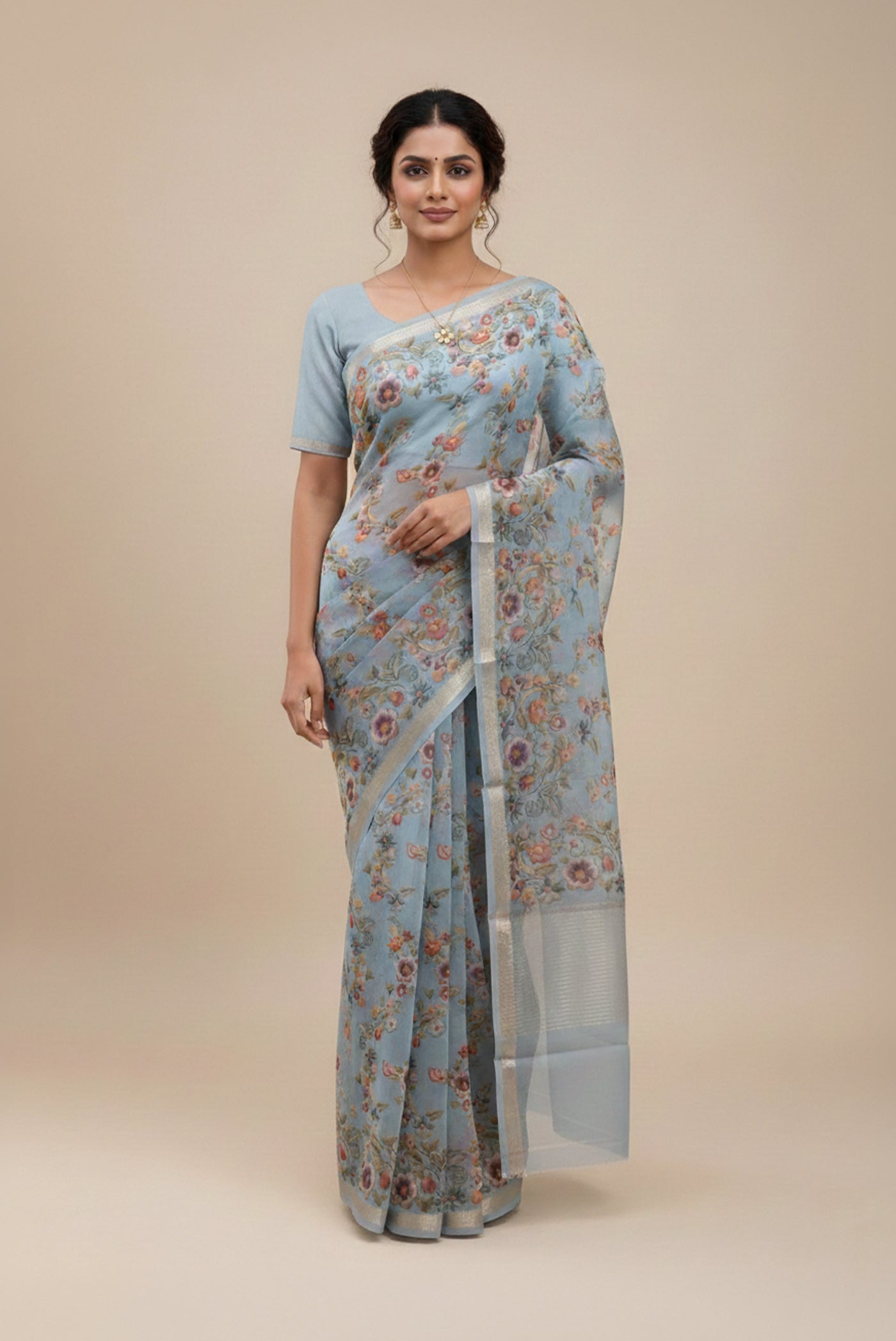 Model wearing a Sky Blue Organza Silk Saree with Floral Print on the body and Zari Border