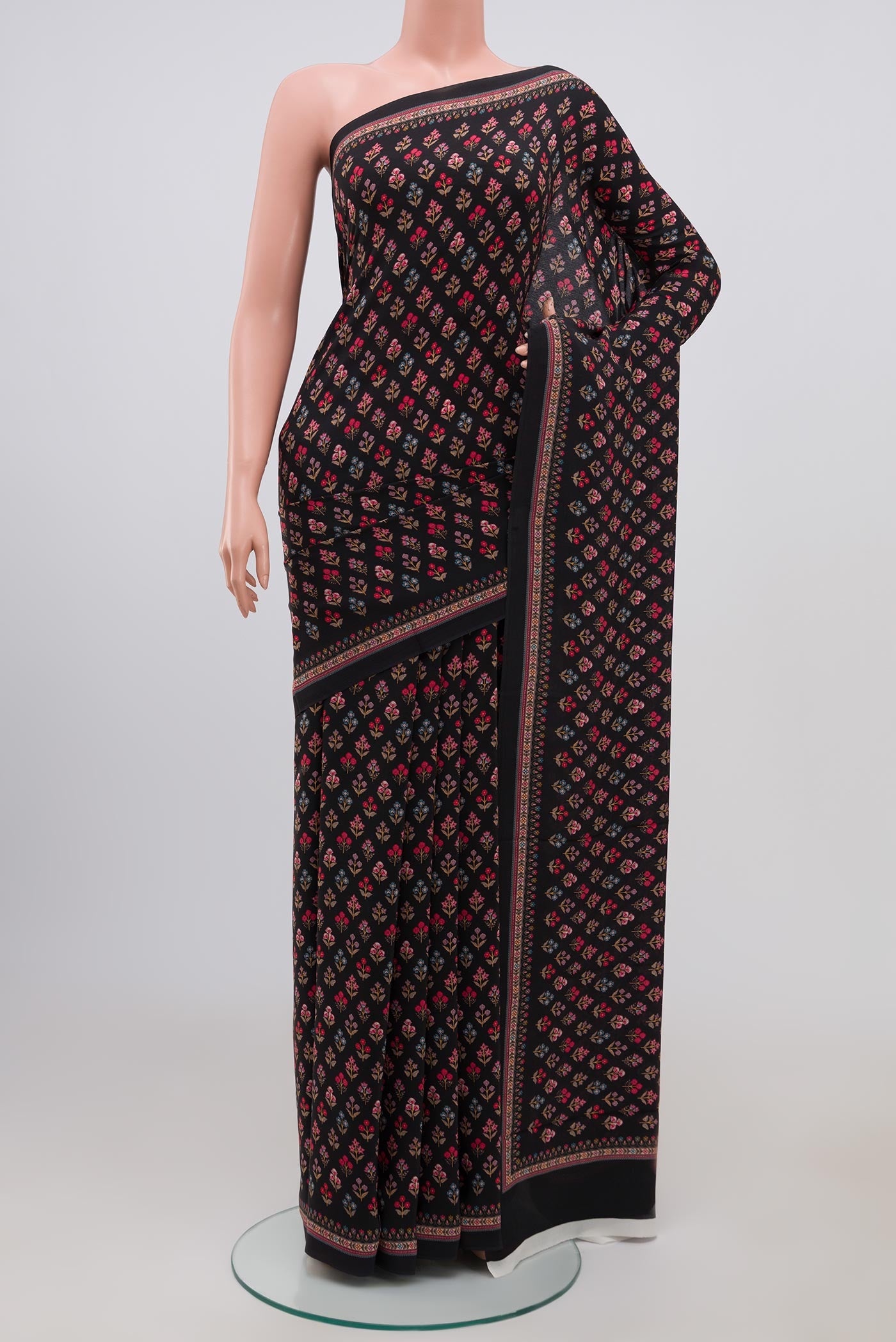 Black Crepe Saree with Printed design on the body and Plain Border.  displayed on a mannequin