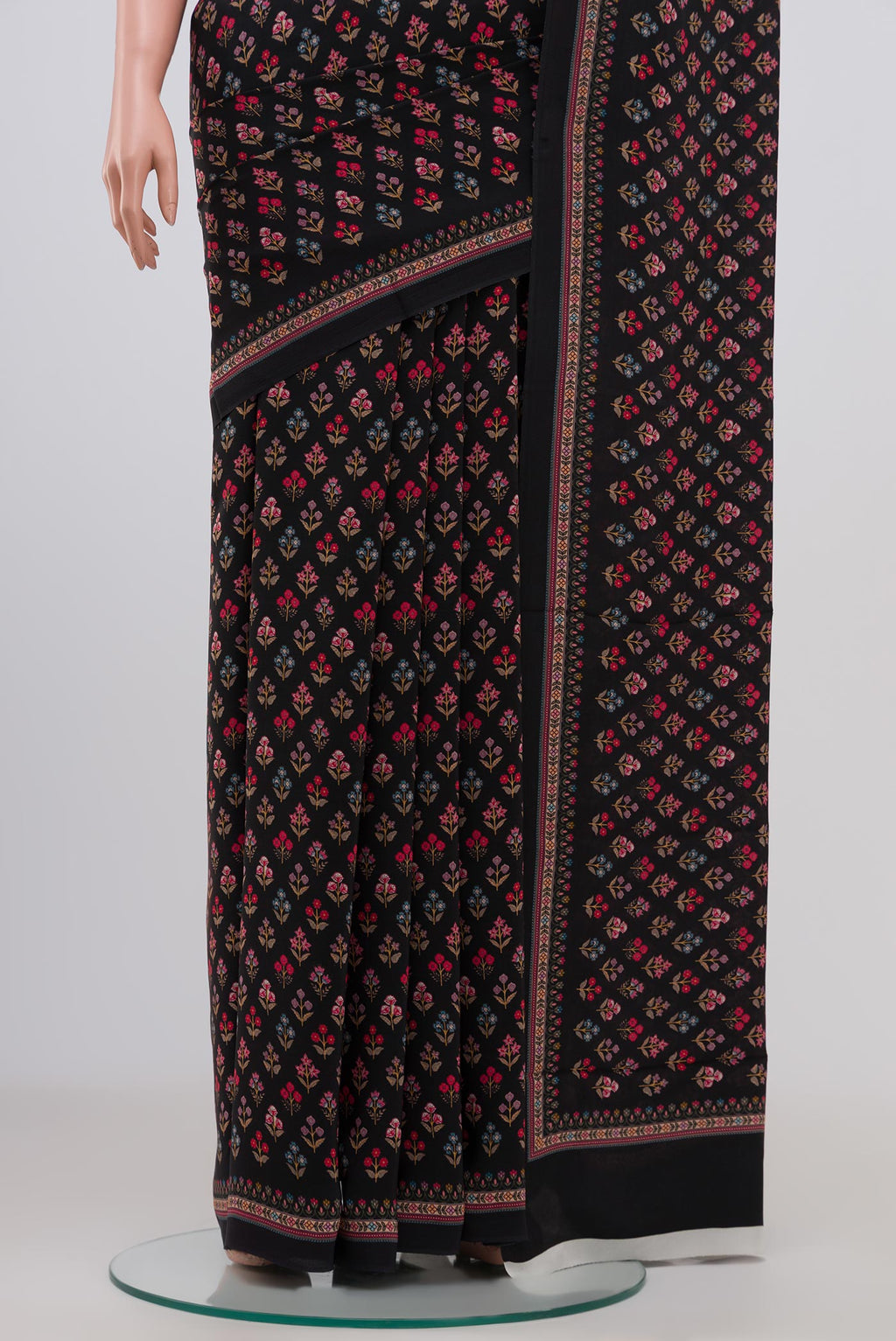 Pleats and pallu of Black Crepe Saree with Printed design on the body and Plain Border. 