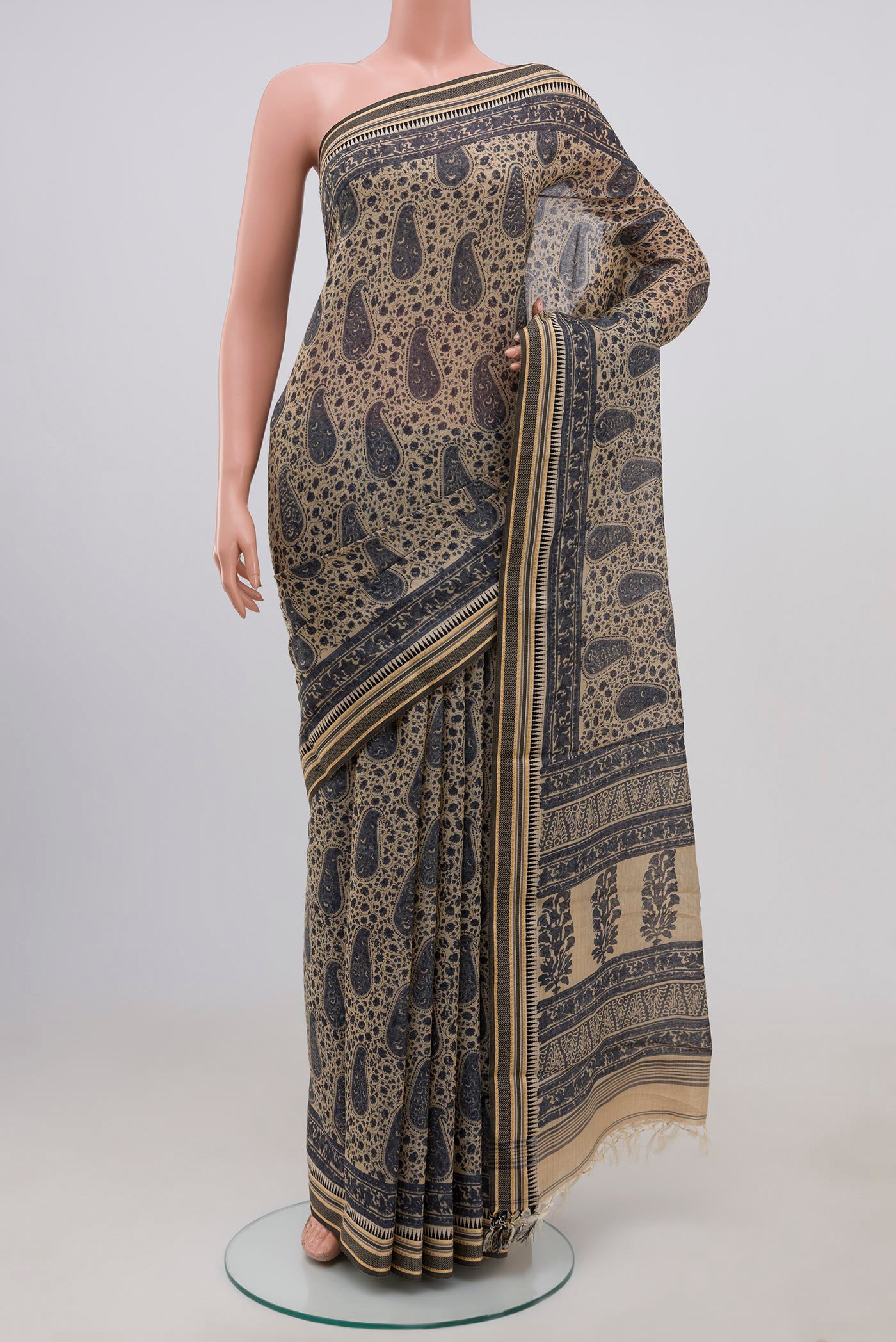 Beige Tussar Saree with Floral Print on the body and Thread Border.  displayed on a mannequin