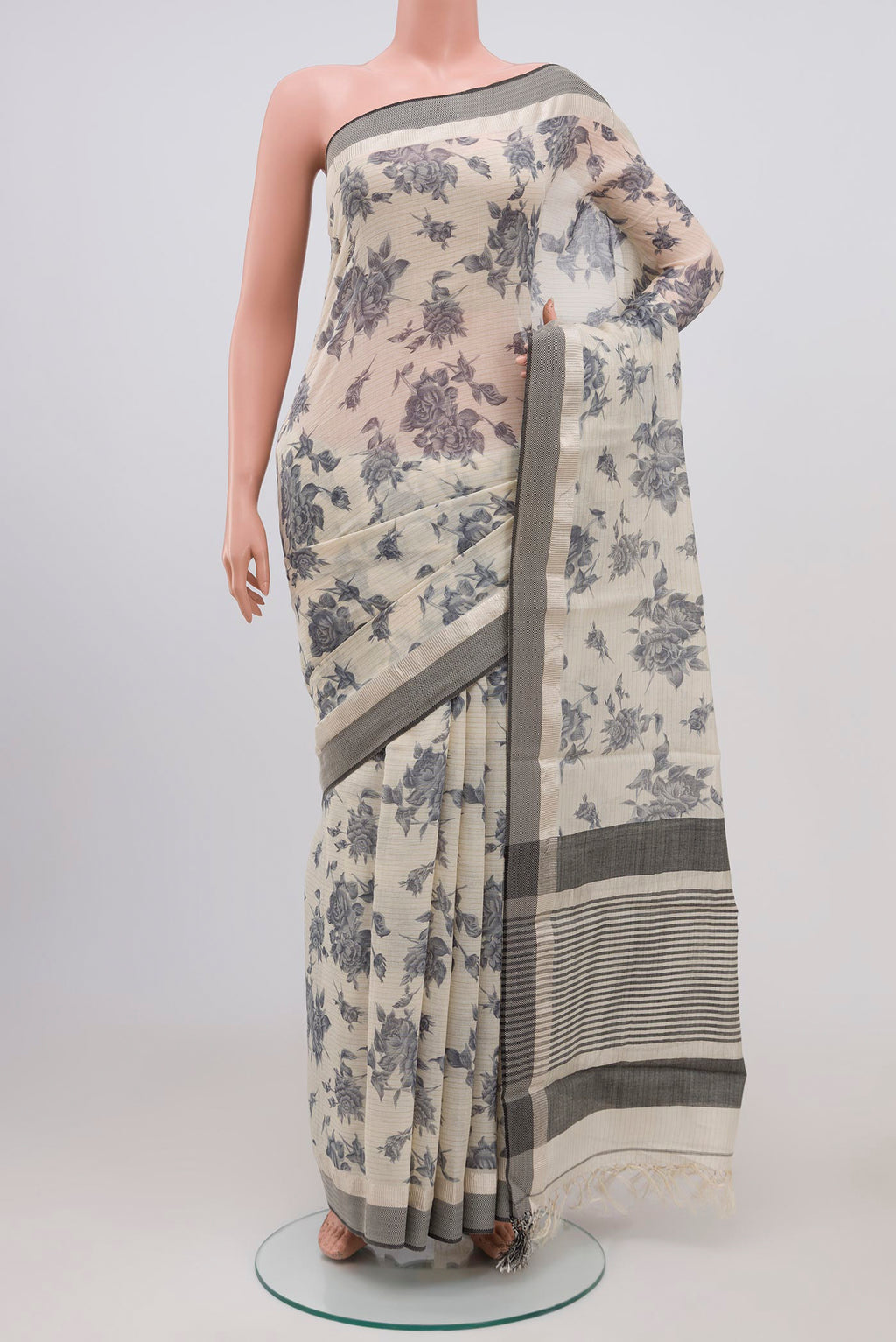 Beige Tussar Saree with Floral Print on the body and Zari Border.  displayed on a mannequin
