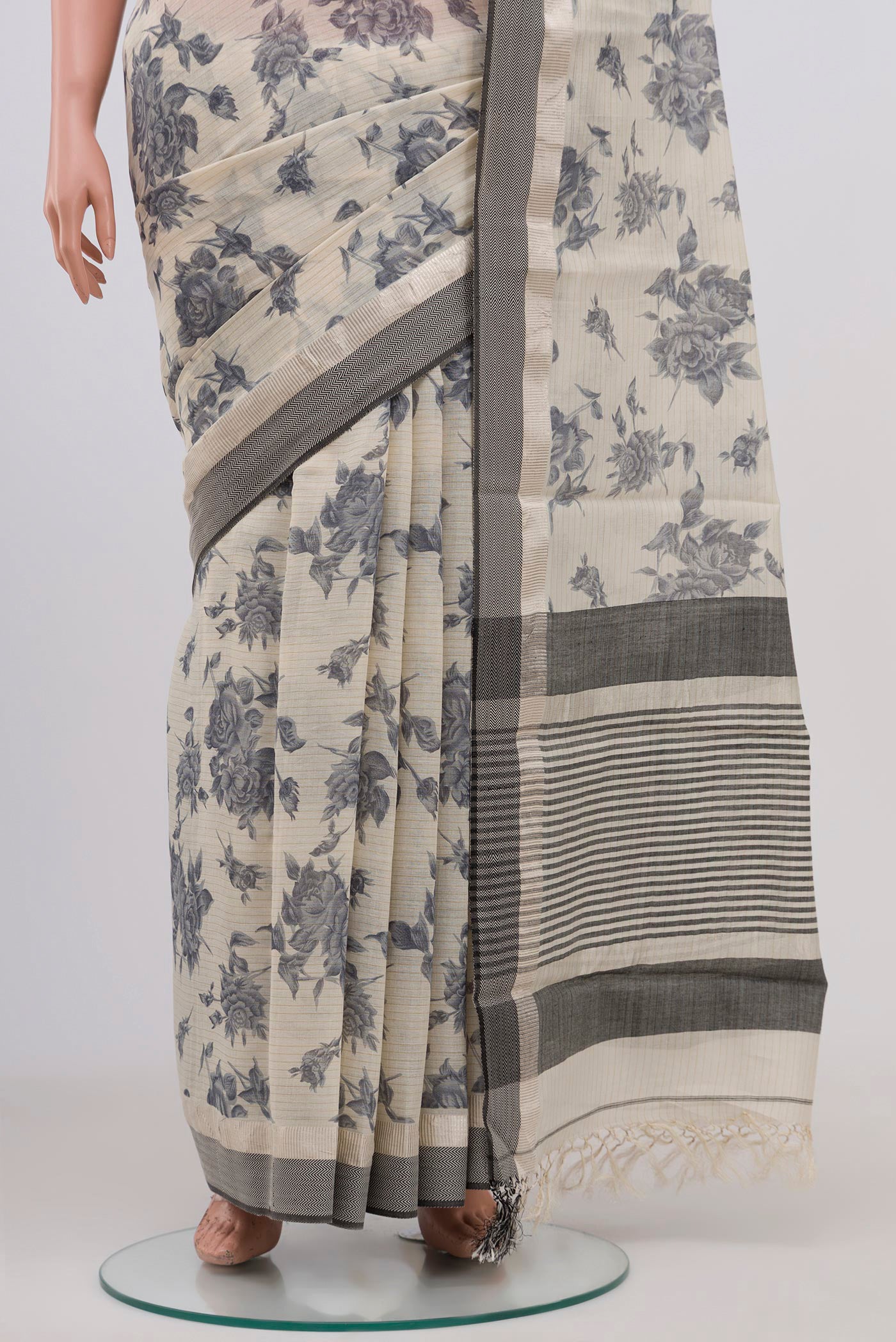 Pleats and pallu of Beige Tussar Saree with Floral Print on the body and Zari Border. 