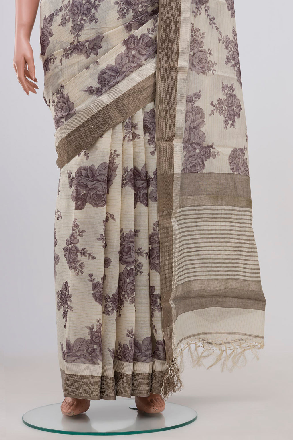 Pleats and pallu of Beige Tussar Saree with Floral Print on the body and Zari Border. 