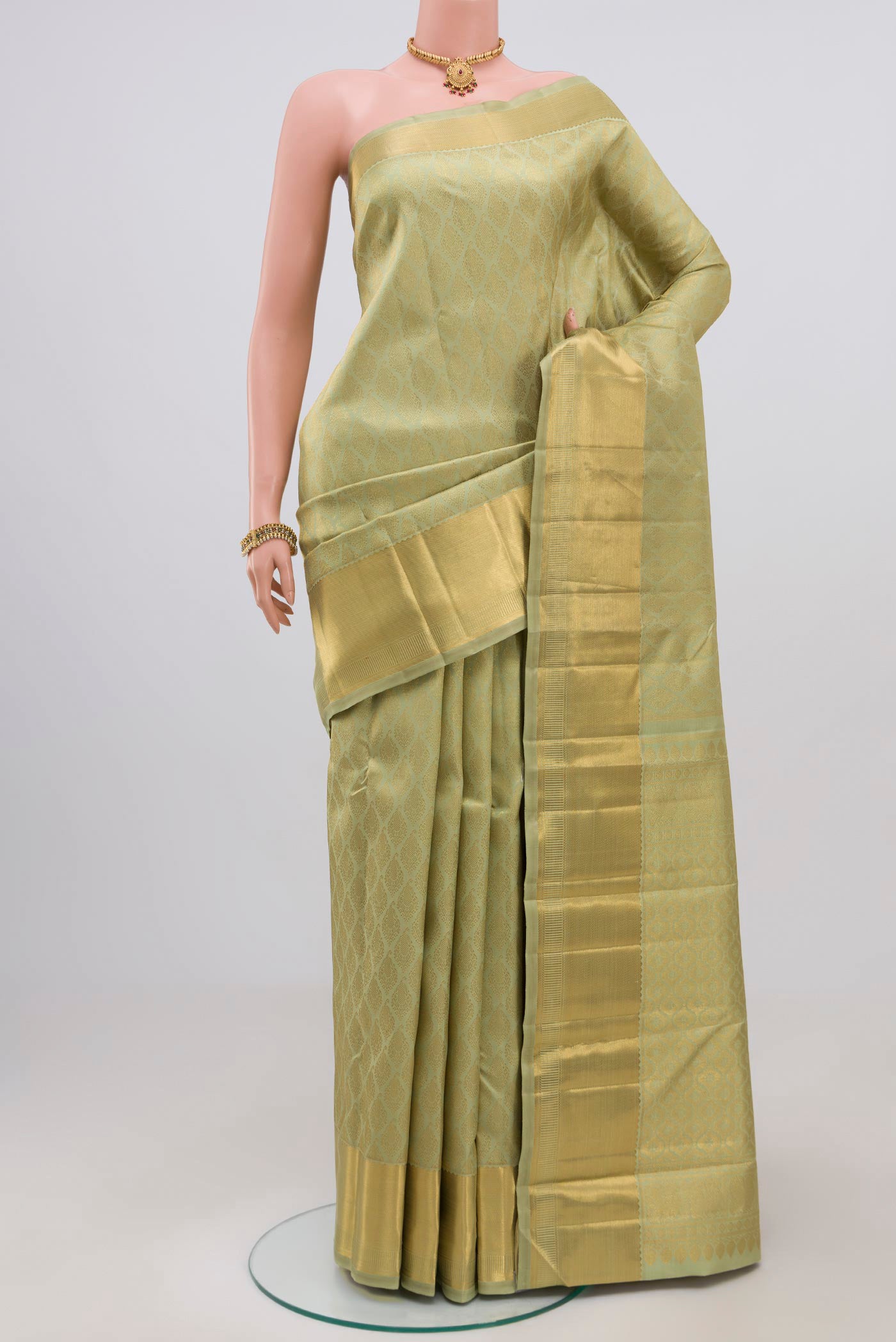 Pure Silk Pure Zari Pista Green Kanjivaram Saree with Zari Brocade on the body and Zari Border.  displayed on a mannequin
